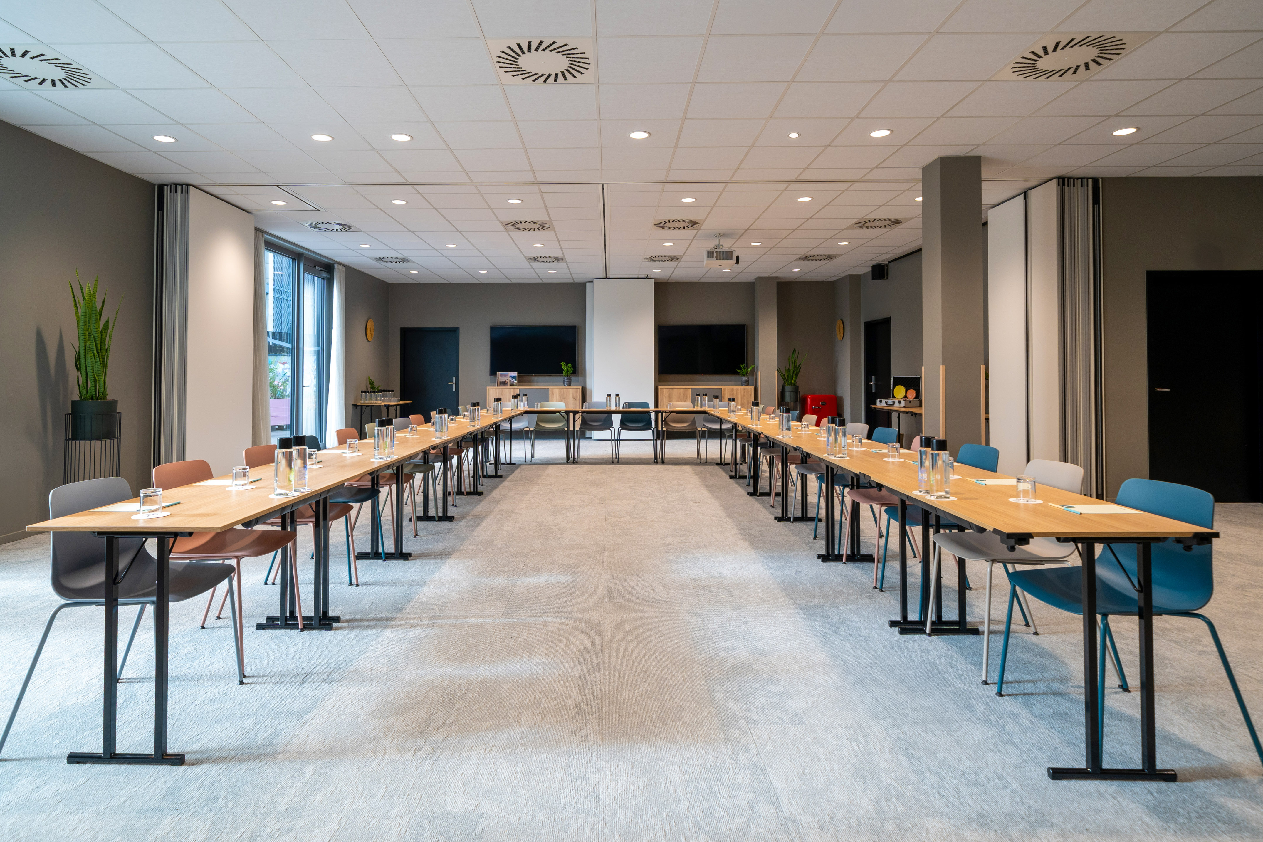 Modern U-shaped meeting room setup for corporate events and presentations.