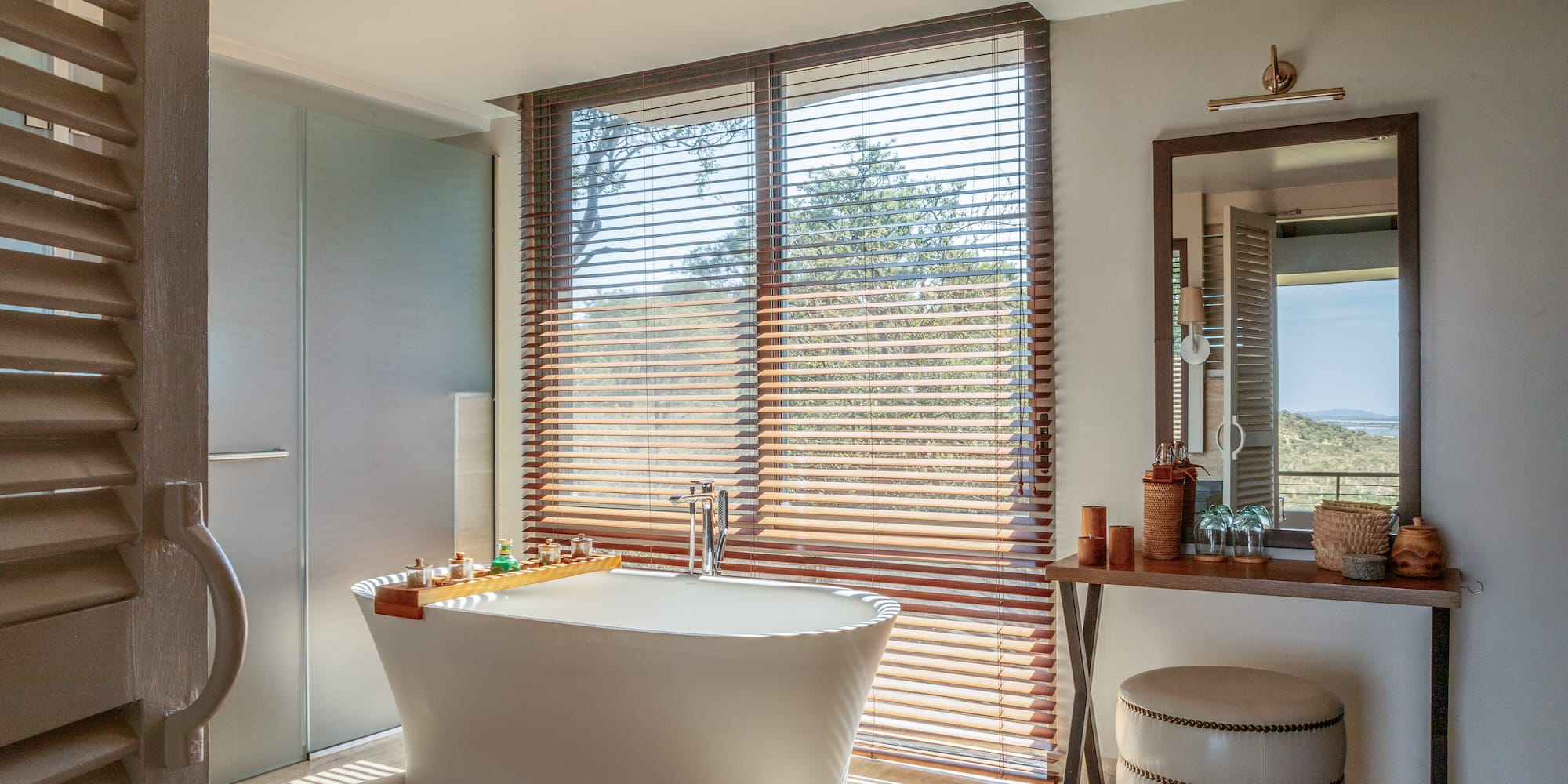 a bathroom with a tub and a mirror