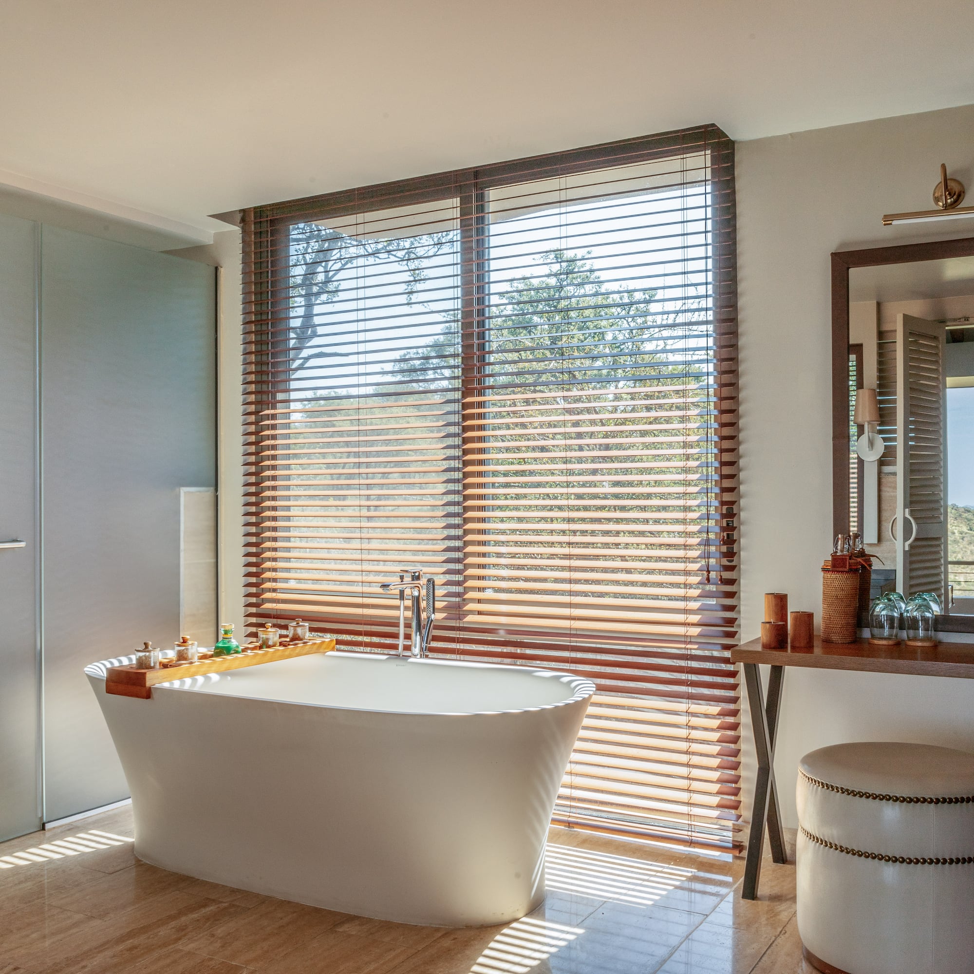 a bathroom with a tub and a mirror
