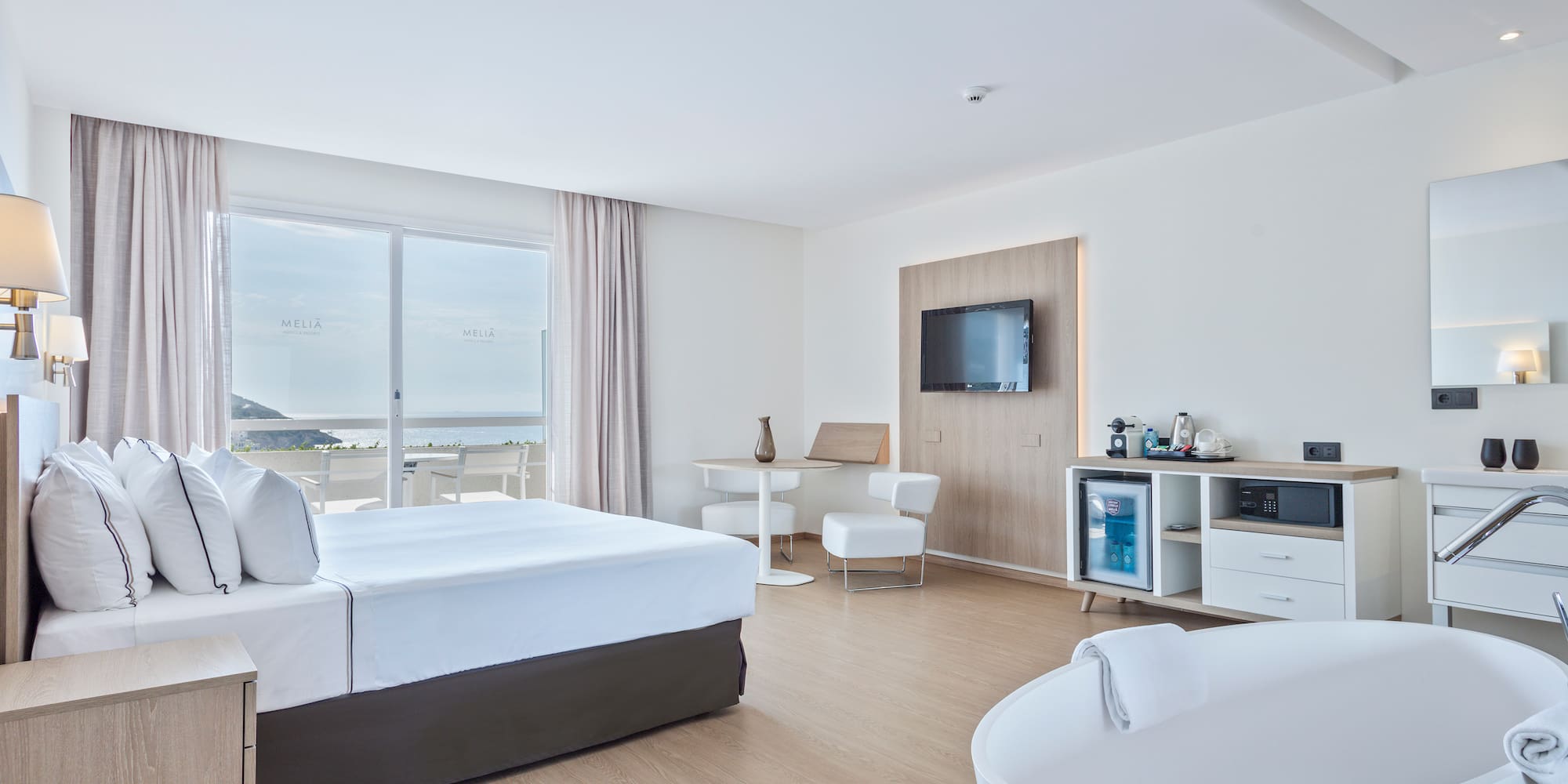 a room with a large bed and a tub