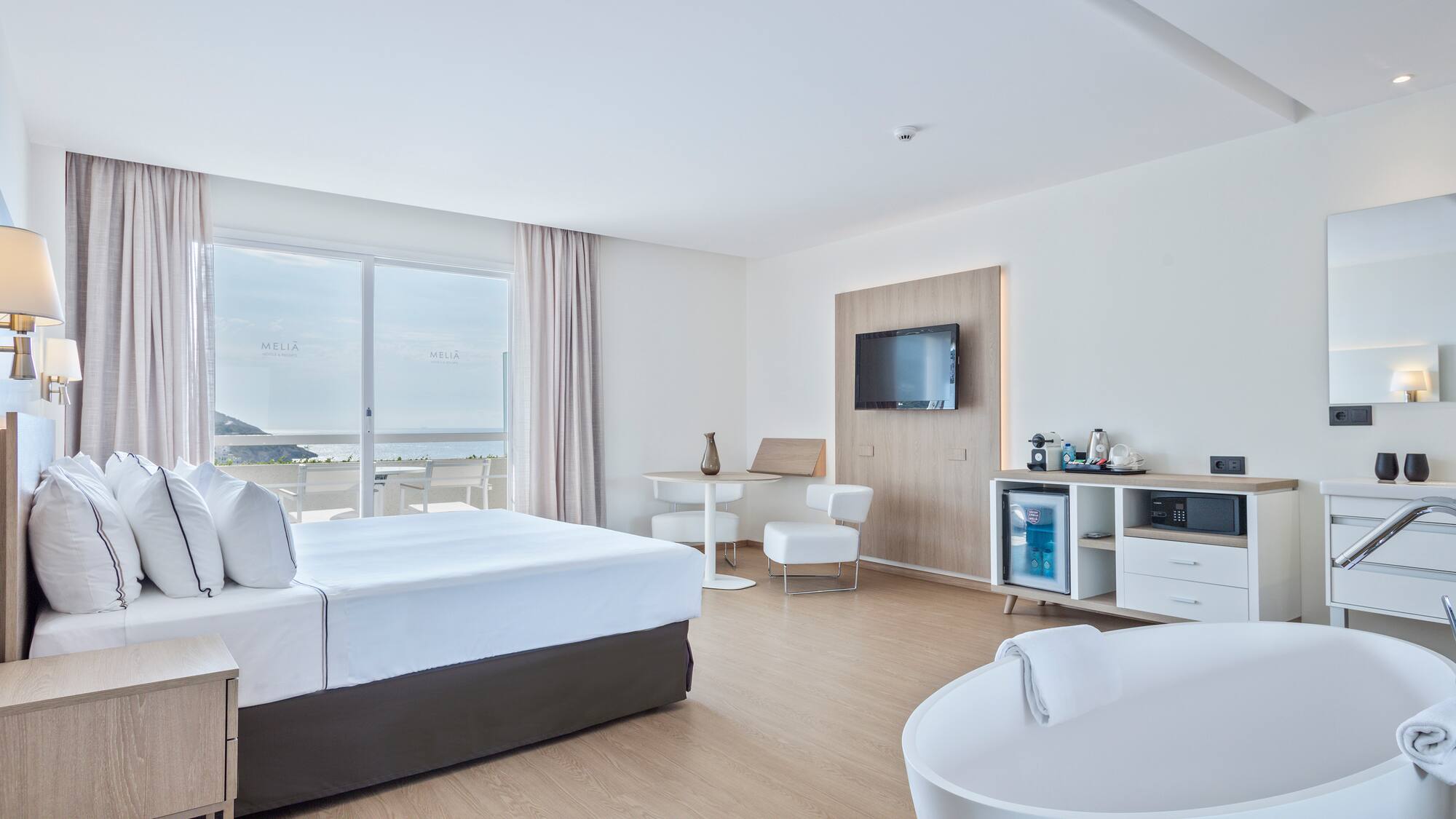 a room with a large bed and a tub