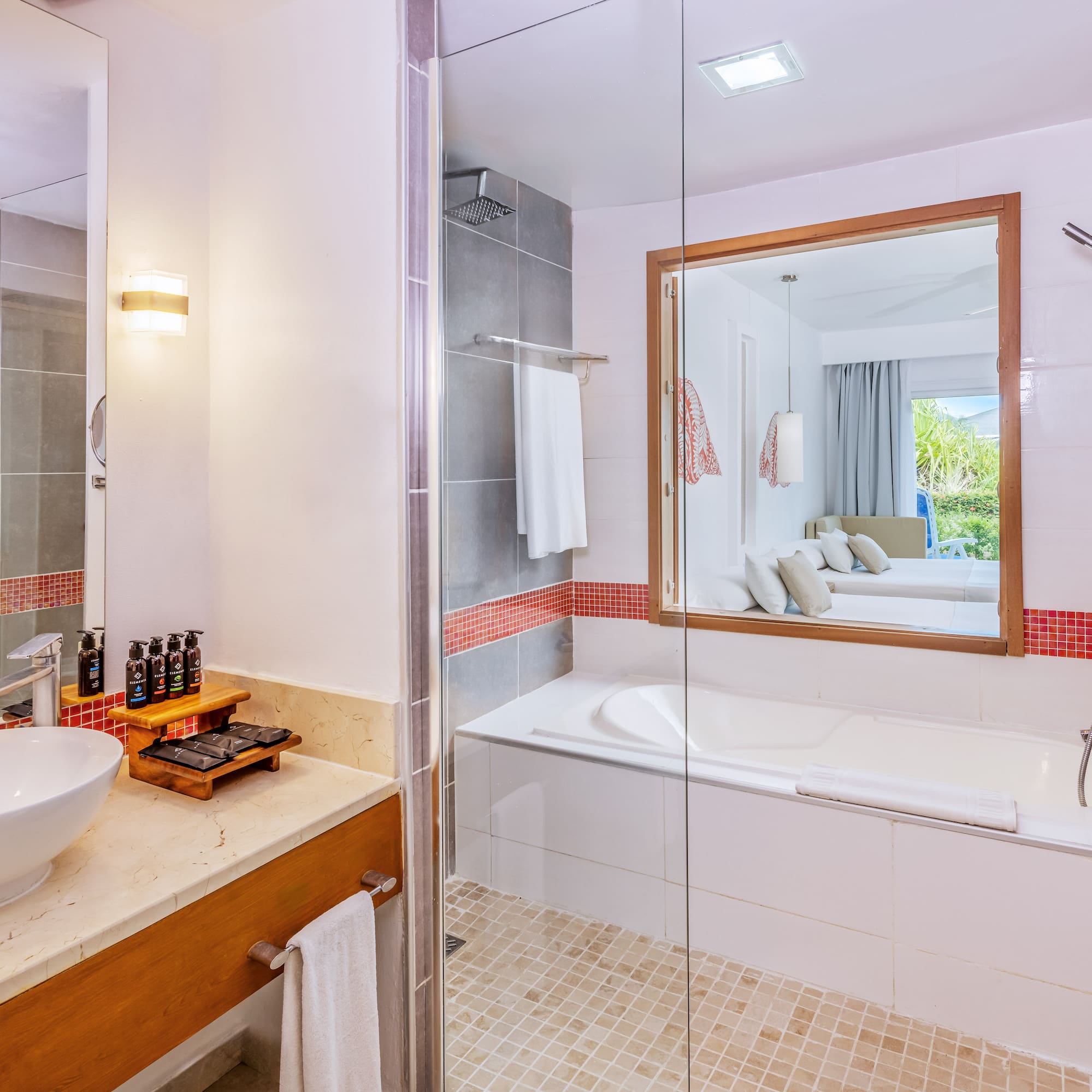 a bathroom with a glass shower door and a sink