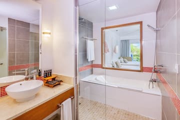 a bathroom with a glass shower door and a sink