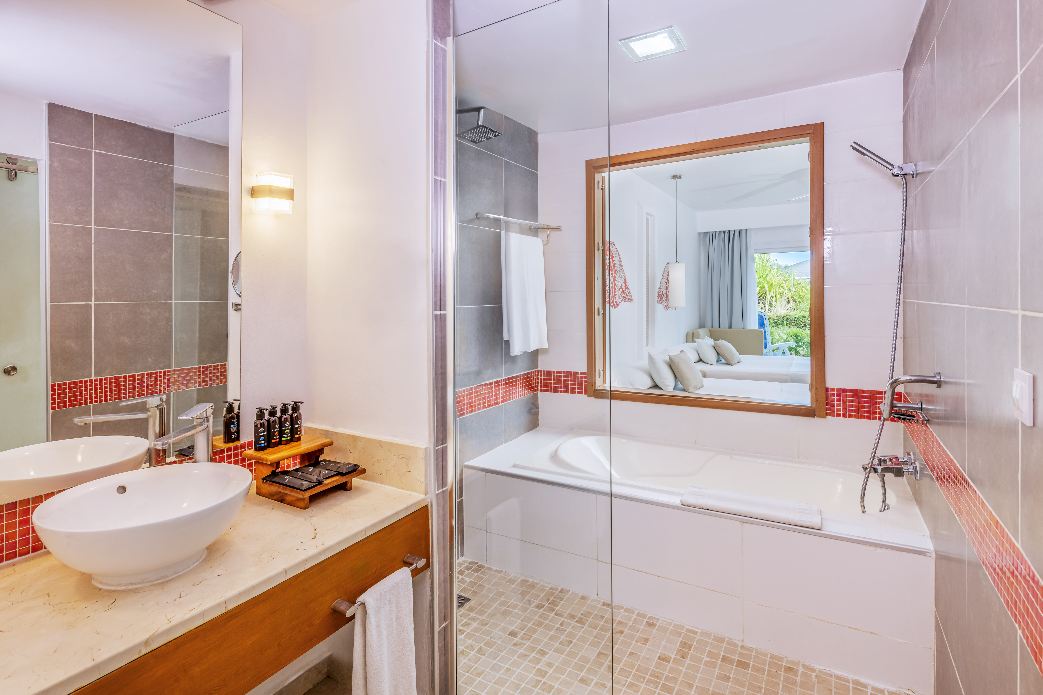 a bathroom with a glass shower door and a sink