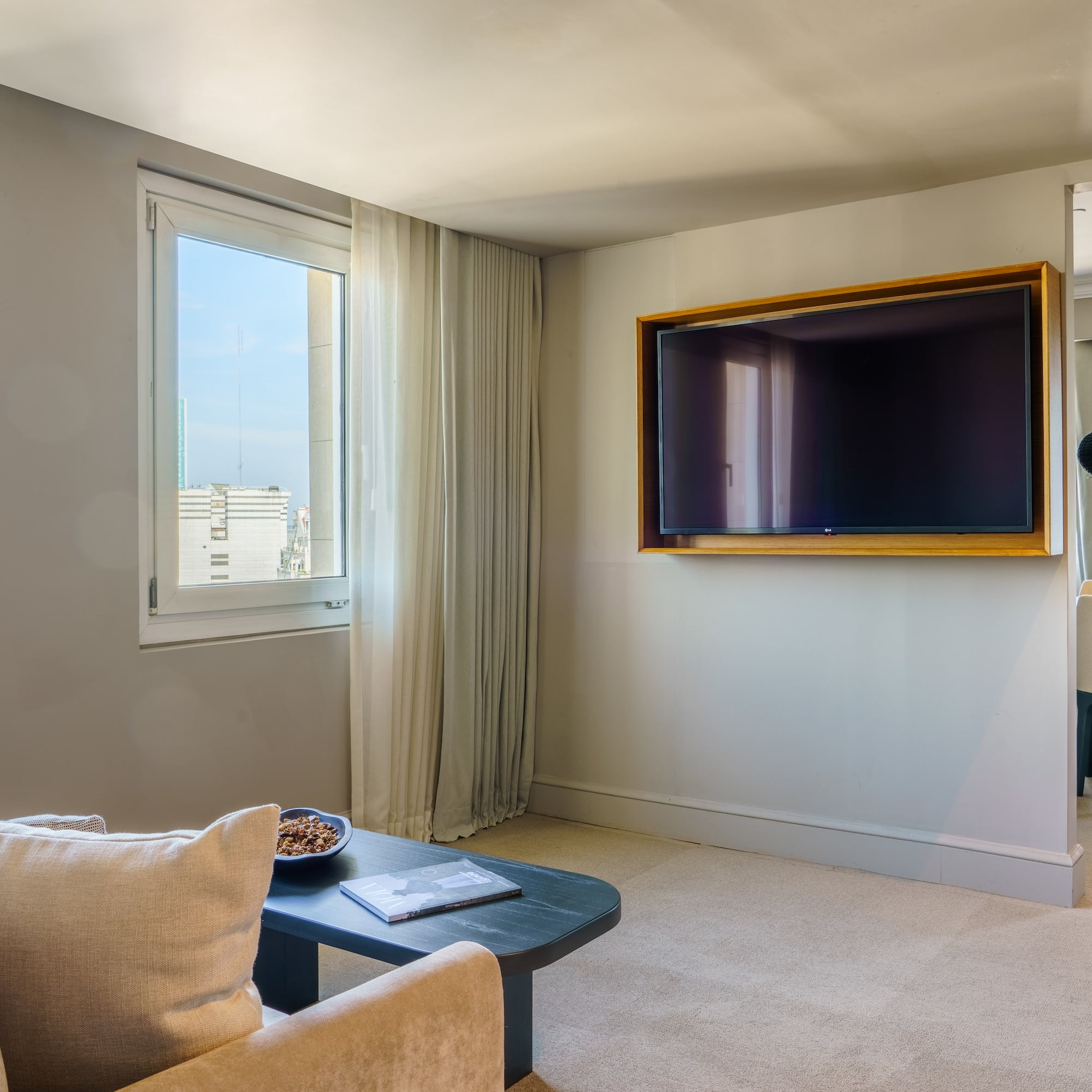 a living room with a television on the wall