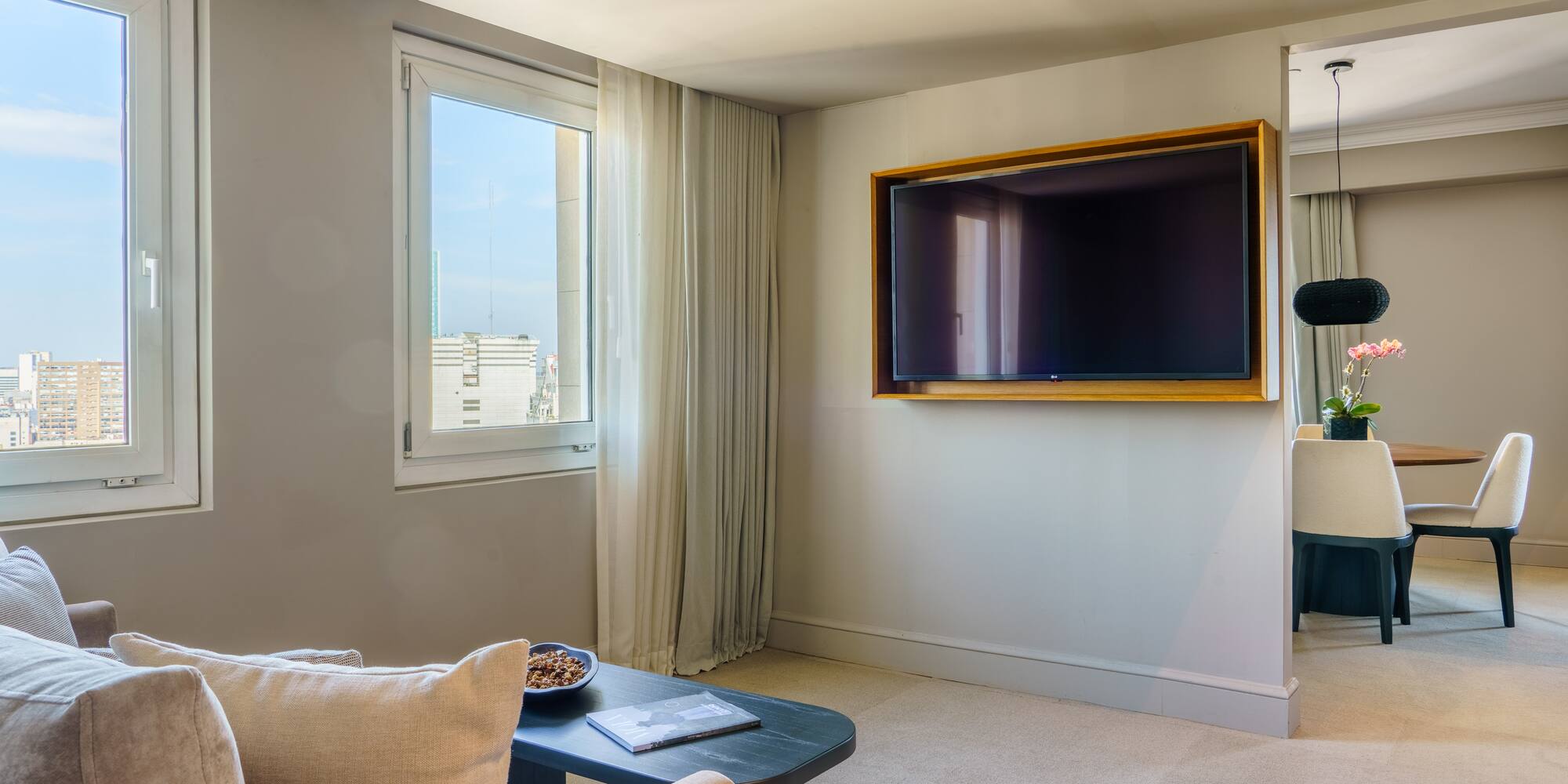 a living room with a television on the wall