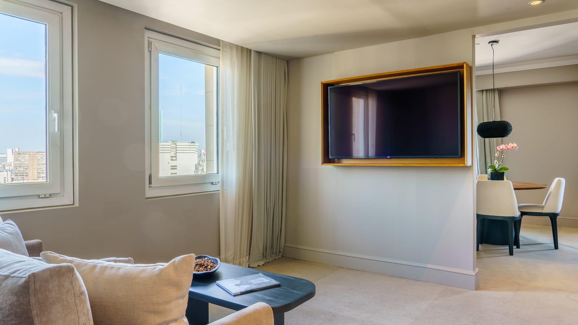 a living room with a television on the wall