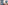 Modern bathroom with red marble vanity, round backlit mirror, and frosted glass shower.