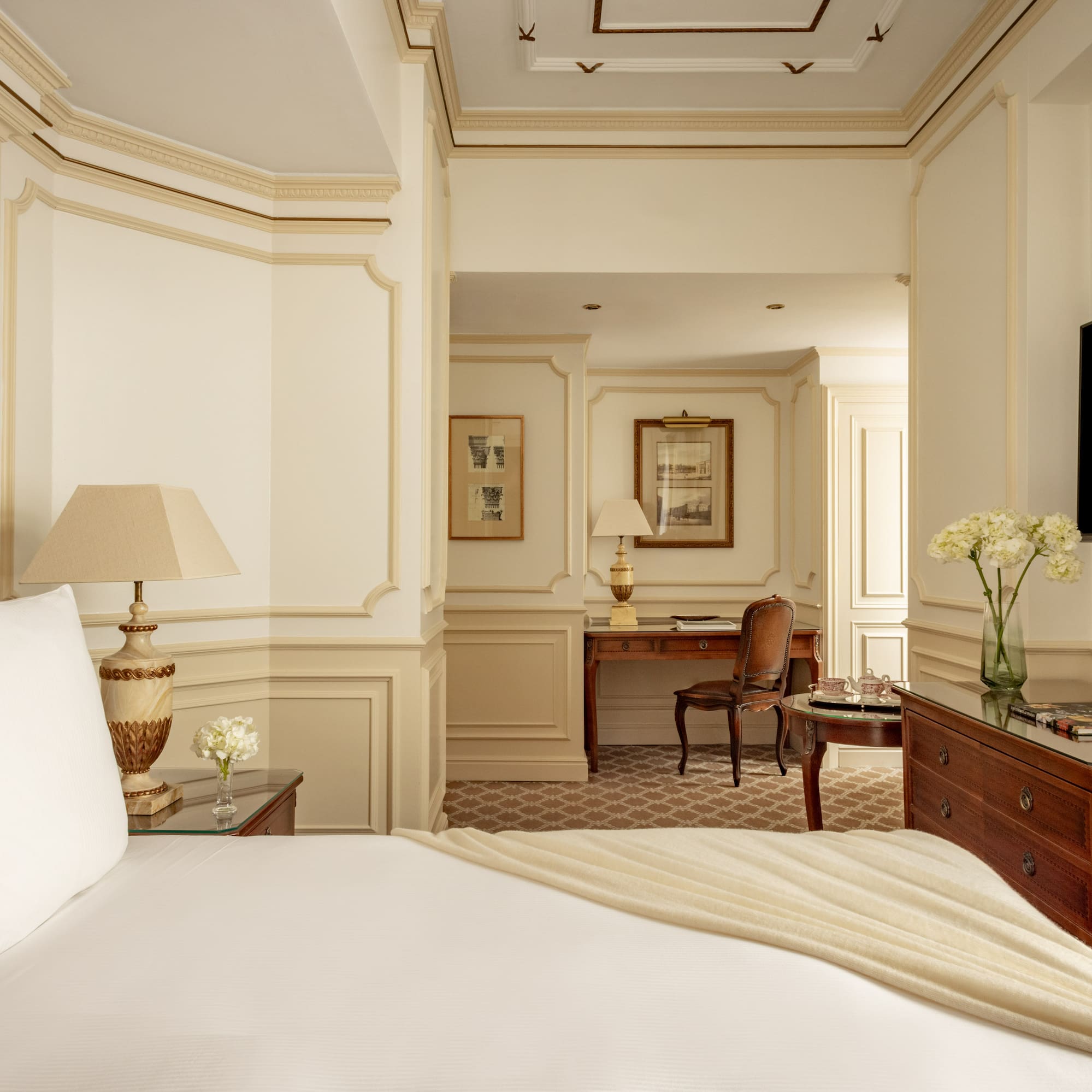 a bedroom with a white bed and a desk