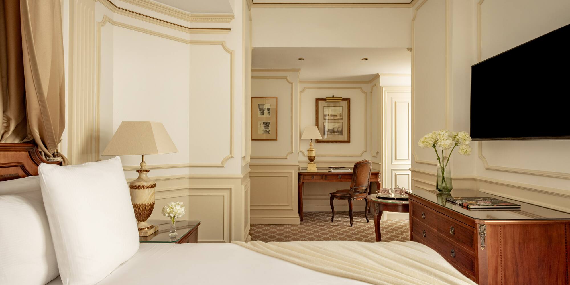 a bedroom with a white bed and a desk