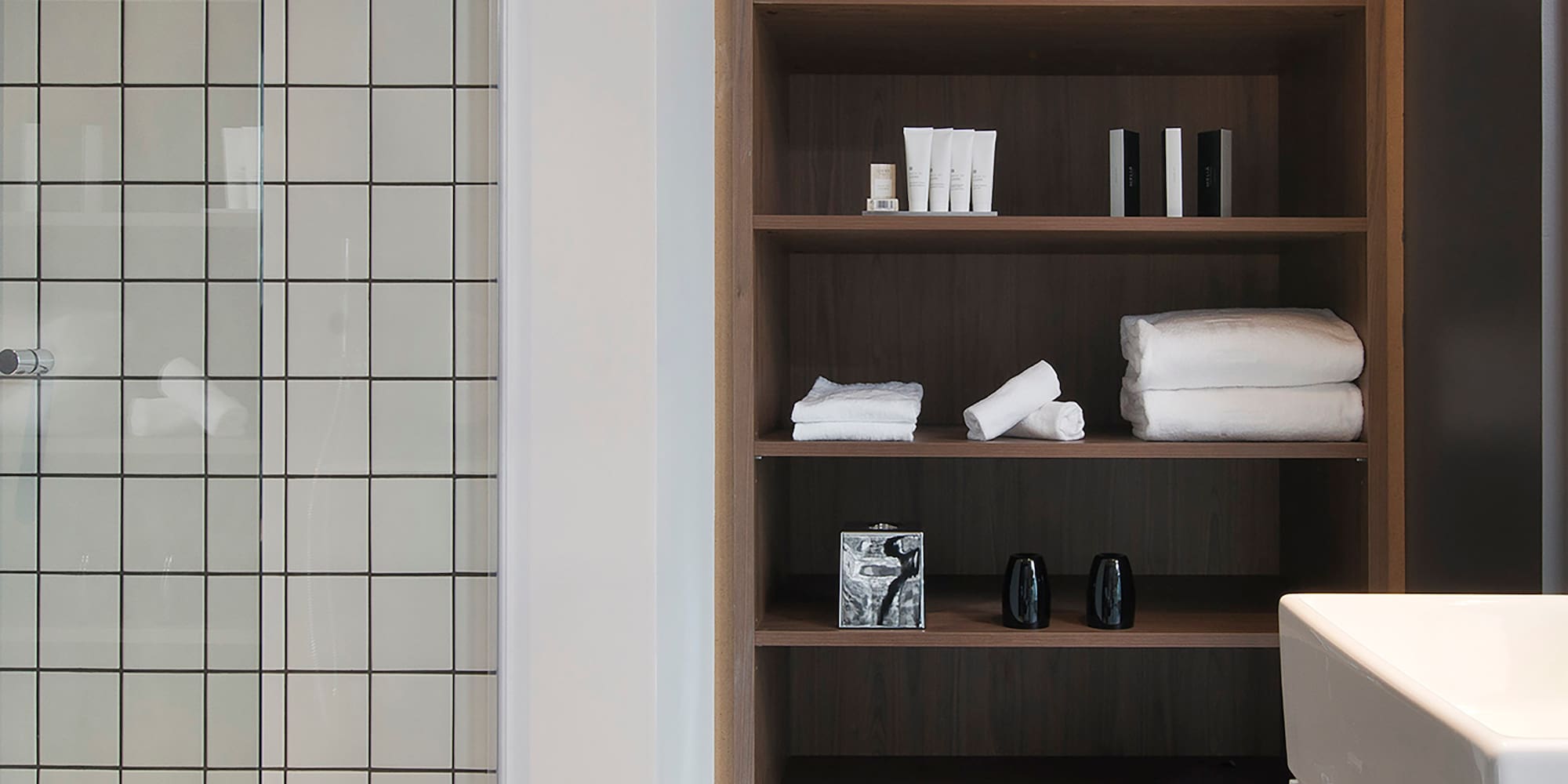 a bathroom with a shower and shelves