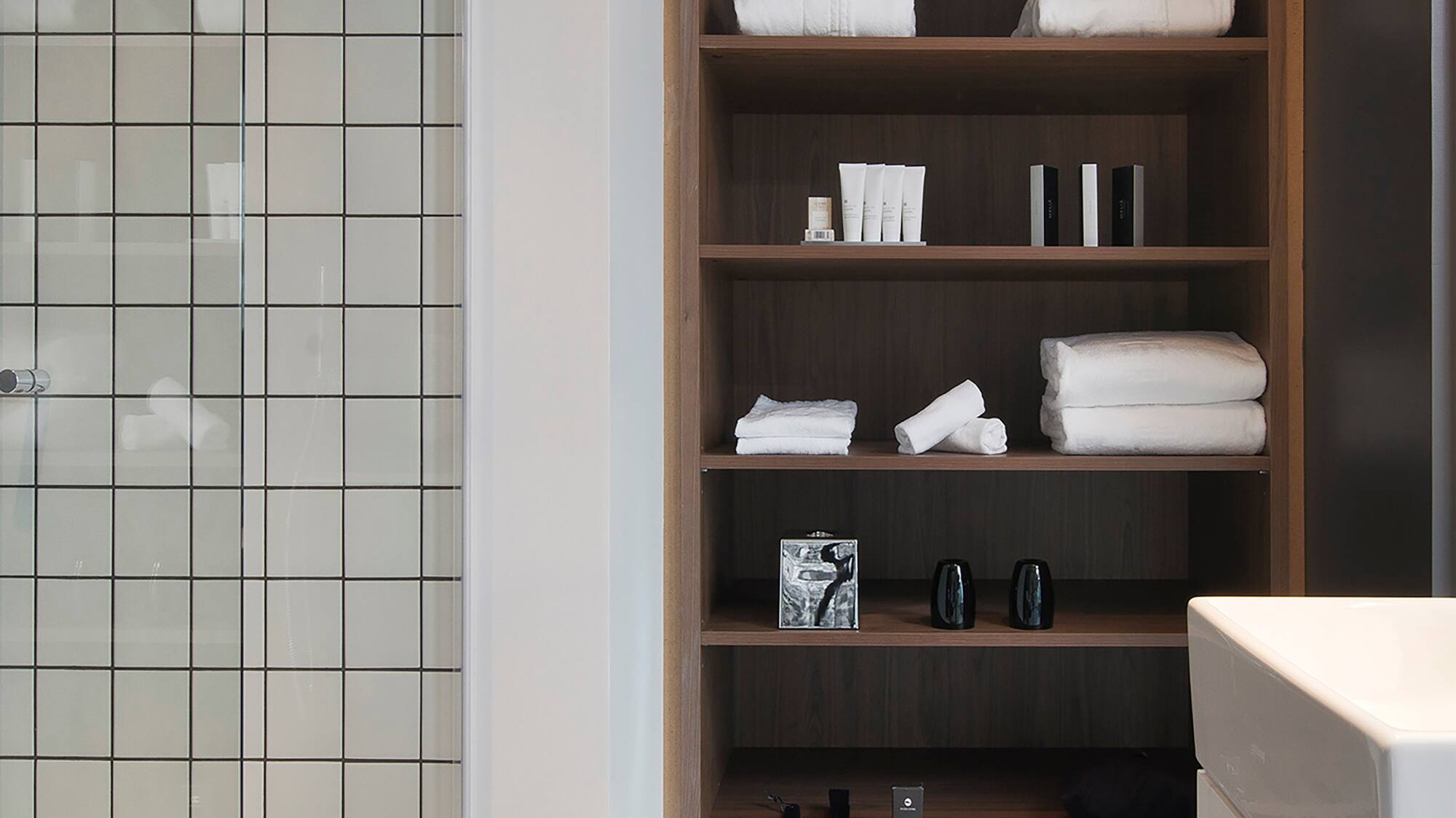 a bathroom with a shower and shelves