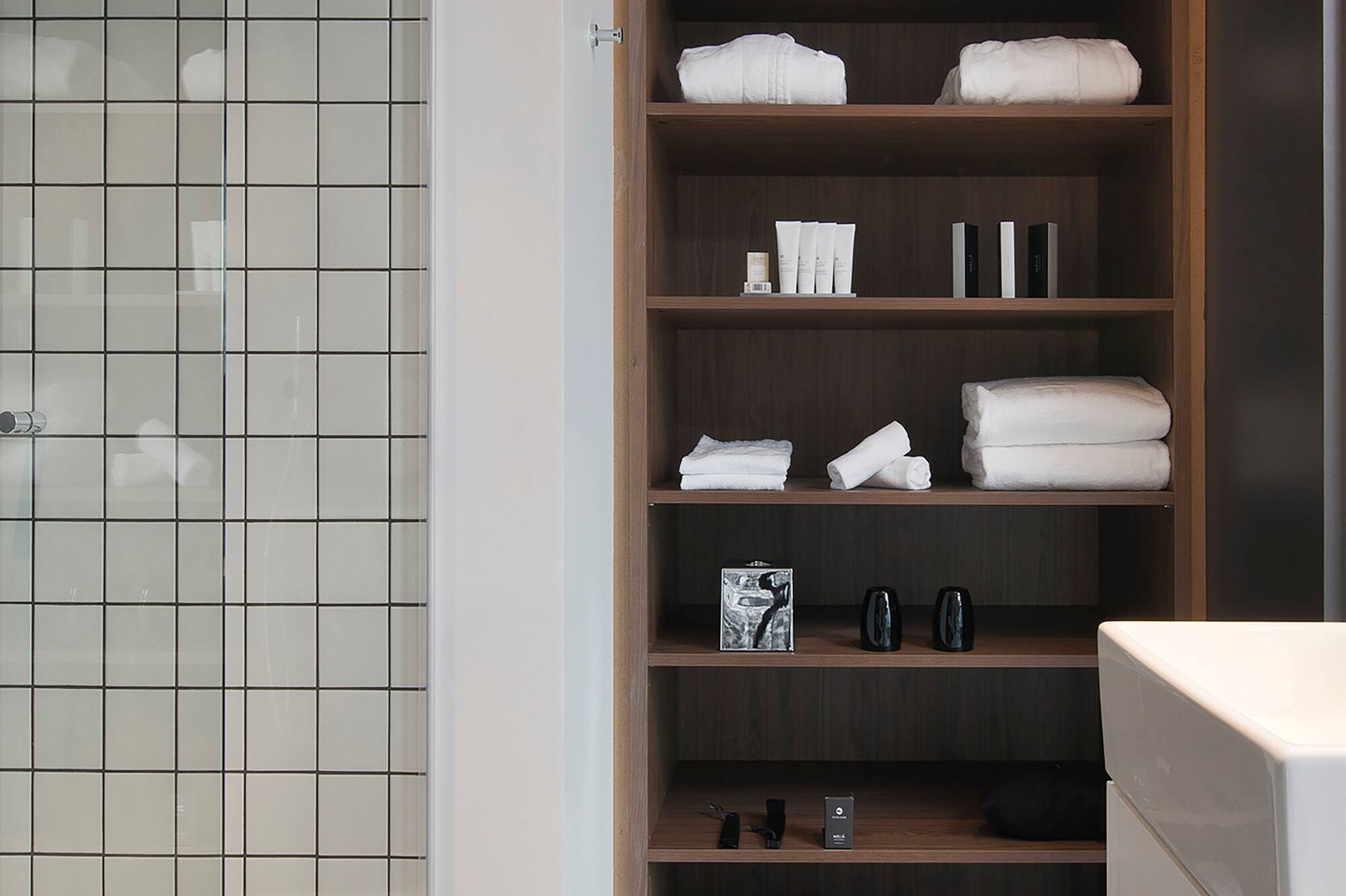 a bathroom with a shower and shelves