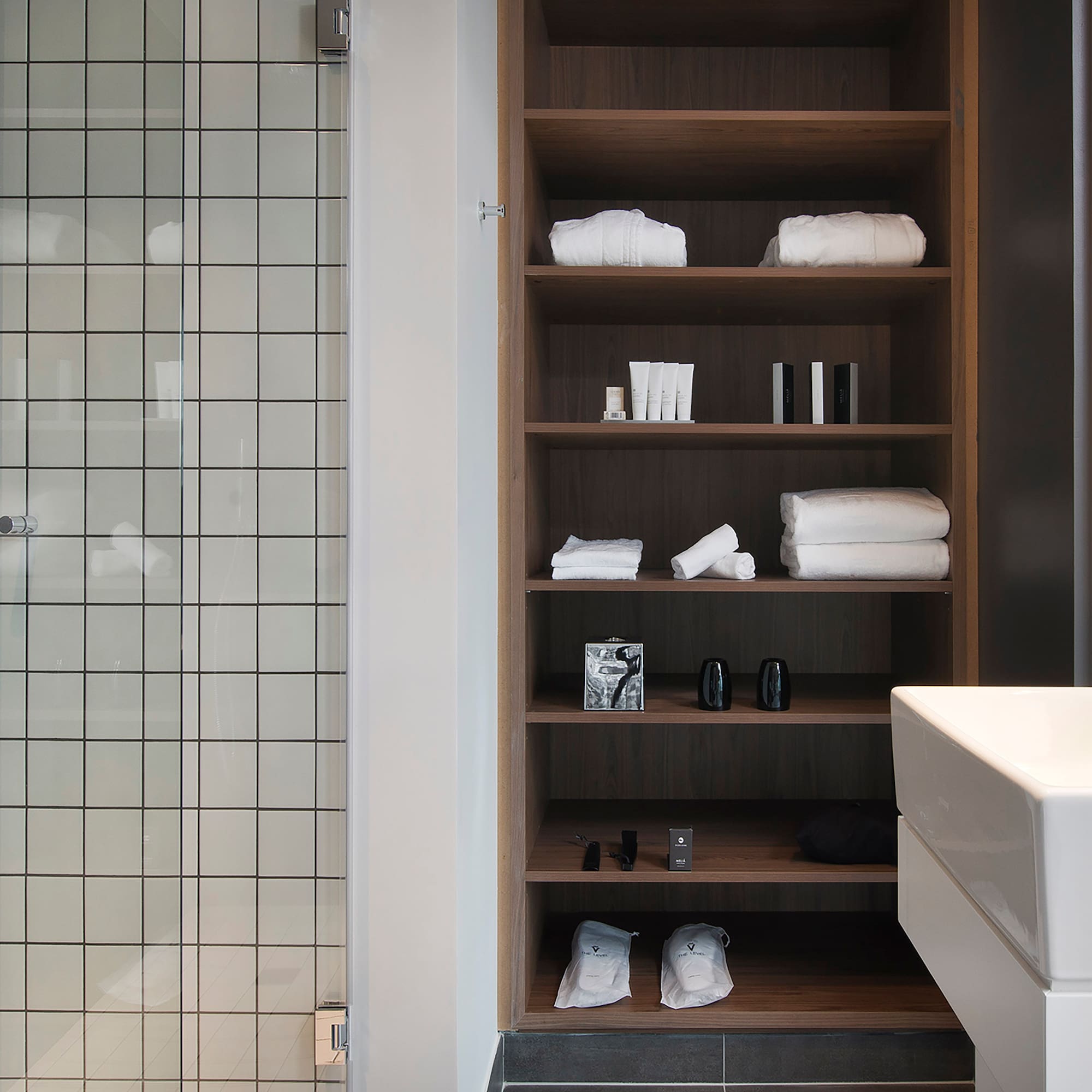 a bathroom with a shower and shelves