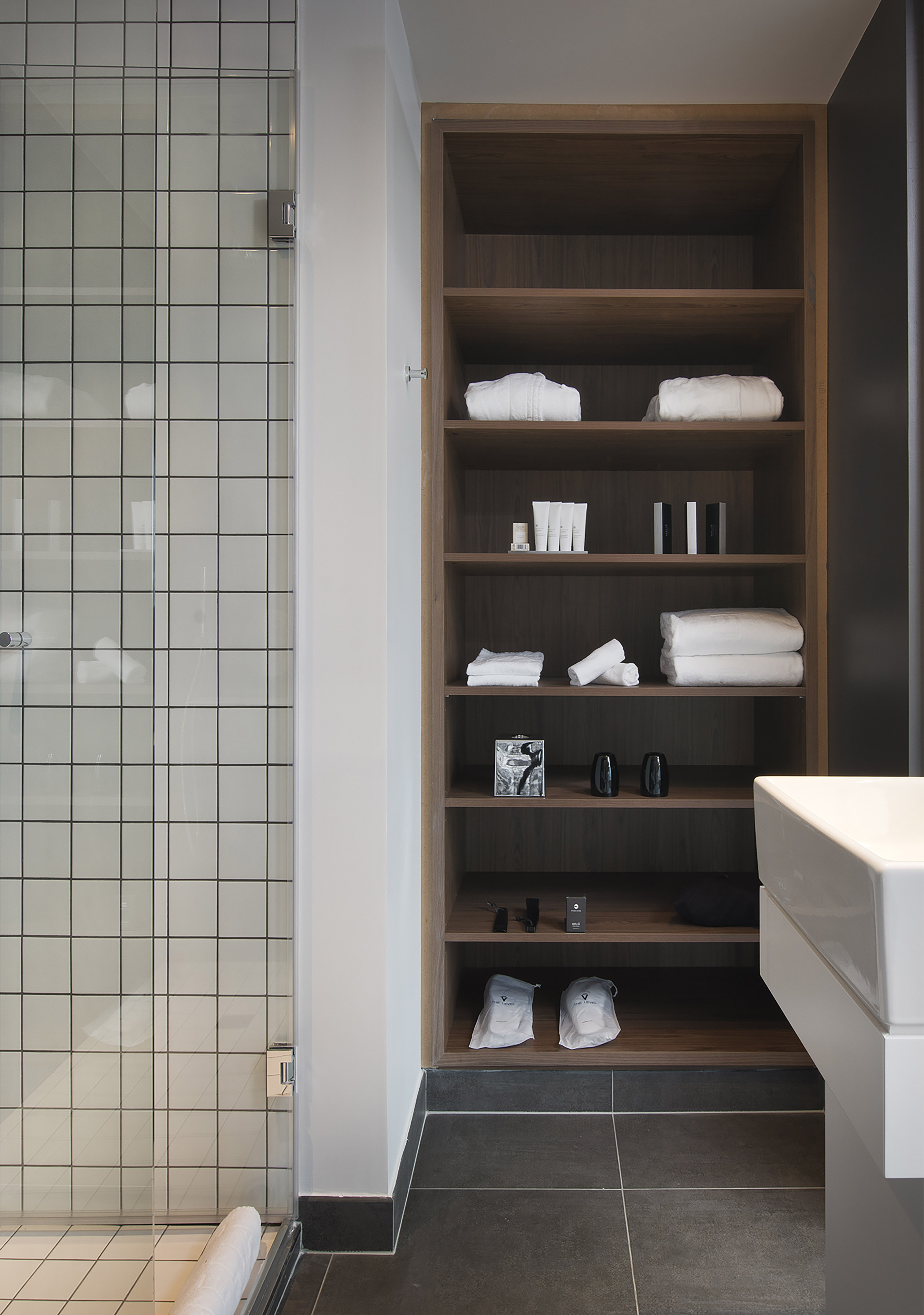 a bathroom with a shower and shelves