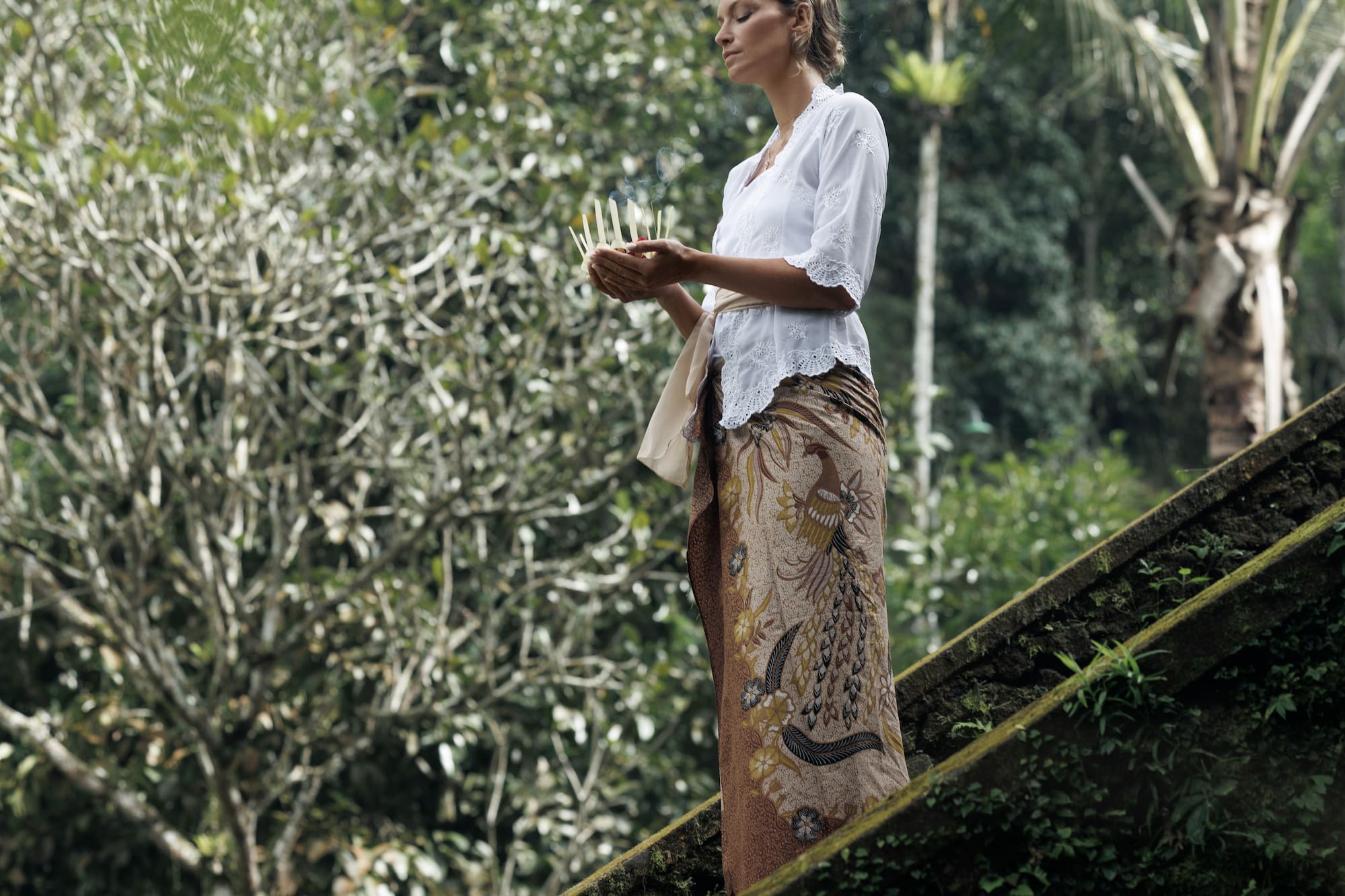 a woman holding candles on stairs