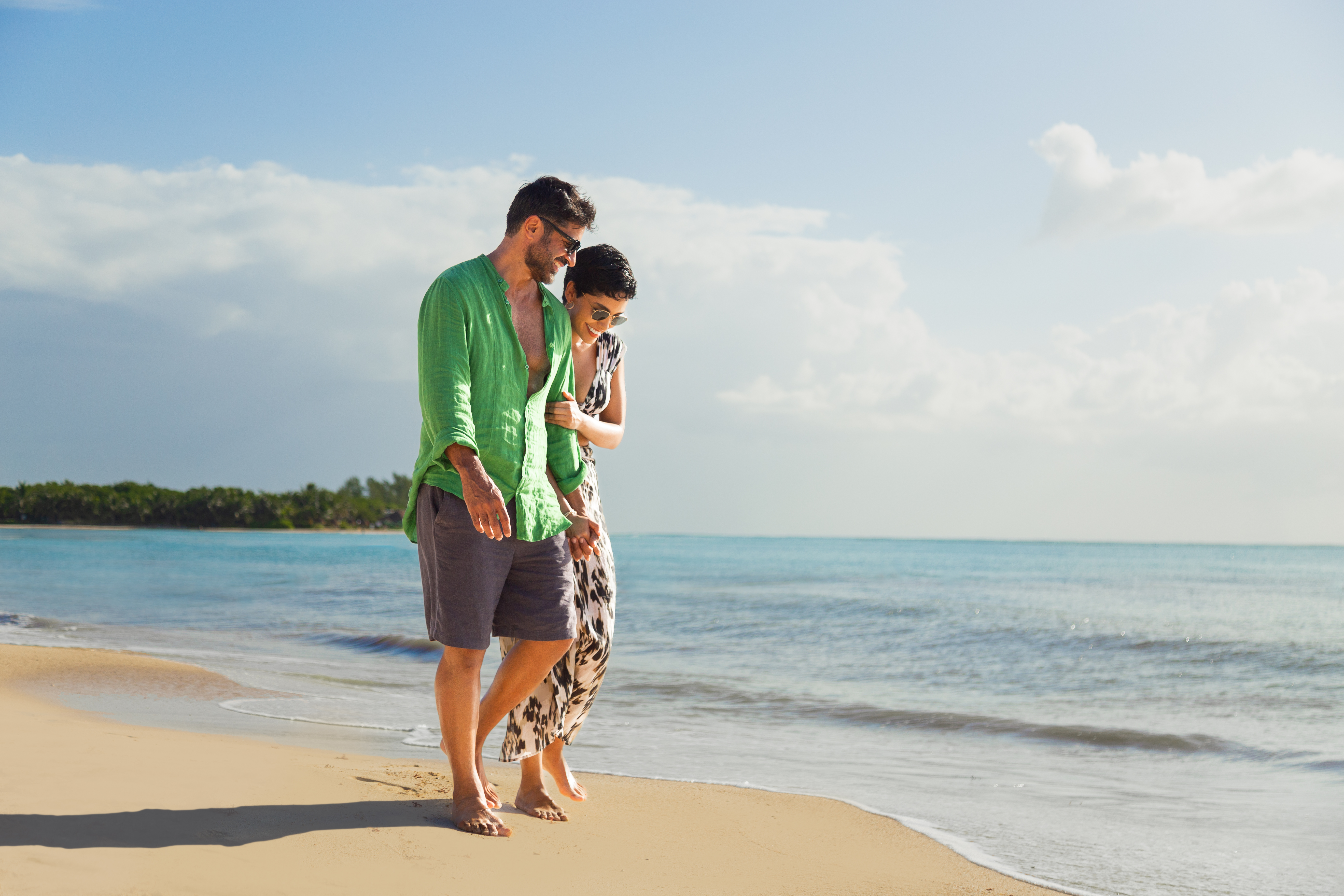 a man and woman standing on a beach
