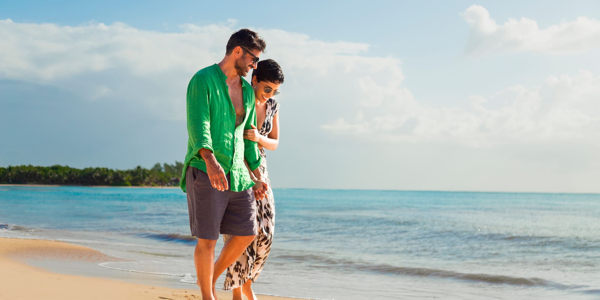 a man and woman standing on a beach