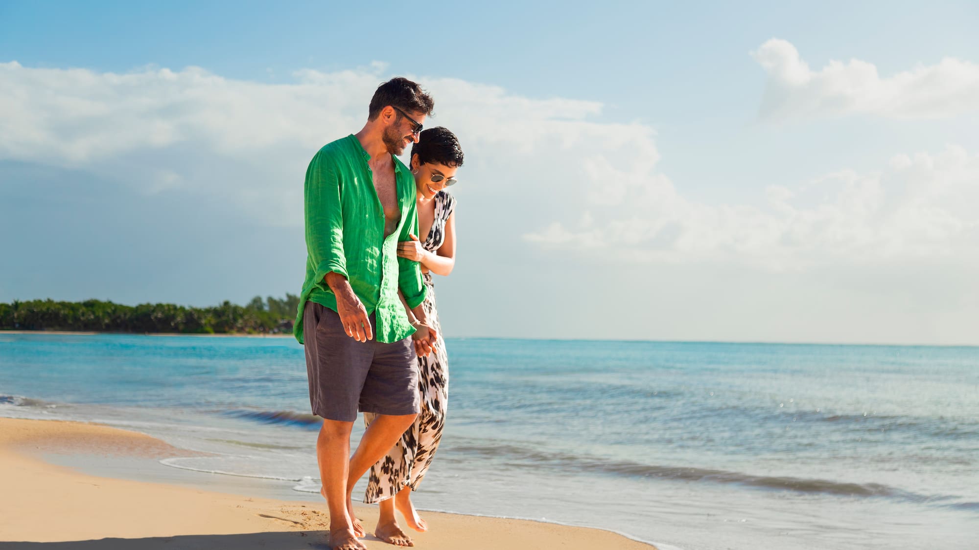 a man and woman standing on a beach