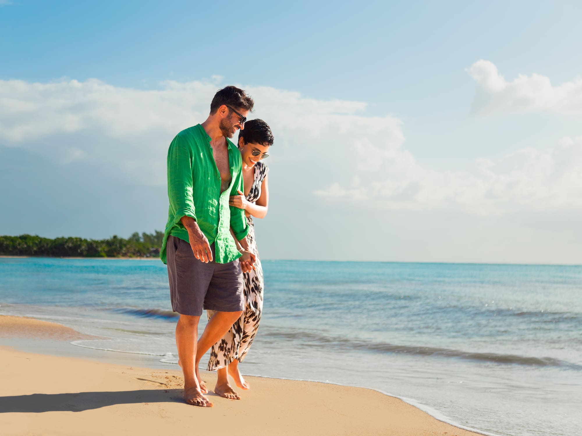 a man and woman standing on a beach