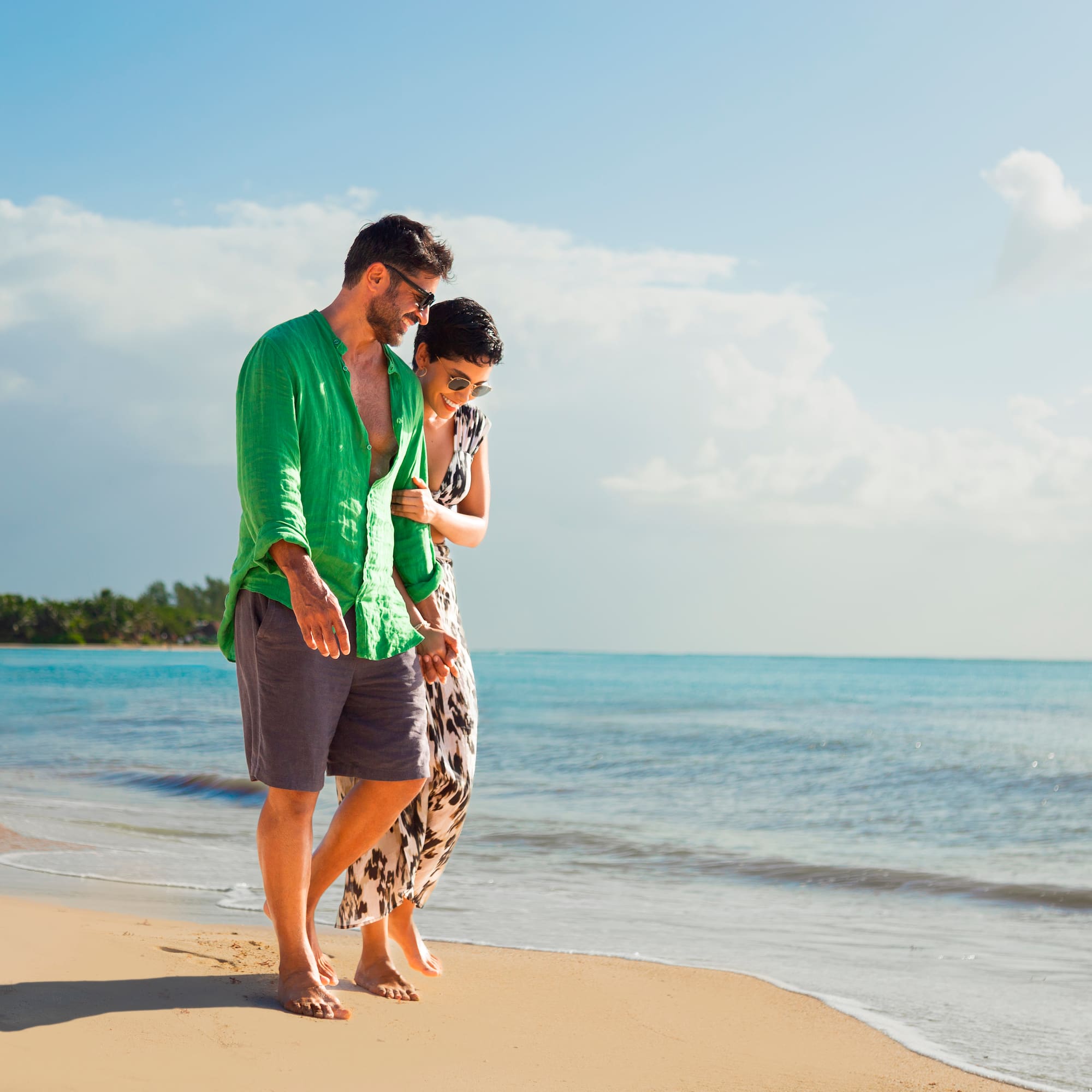 a man and woman standing on a beach