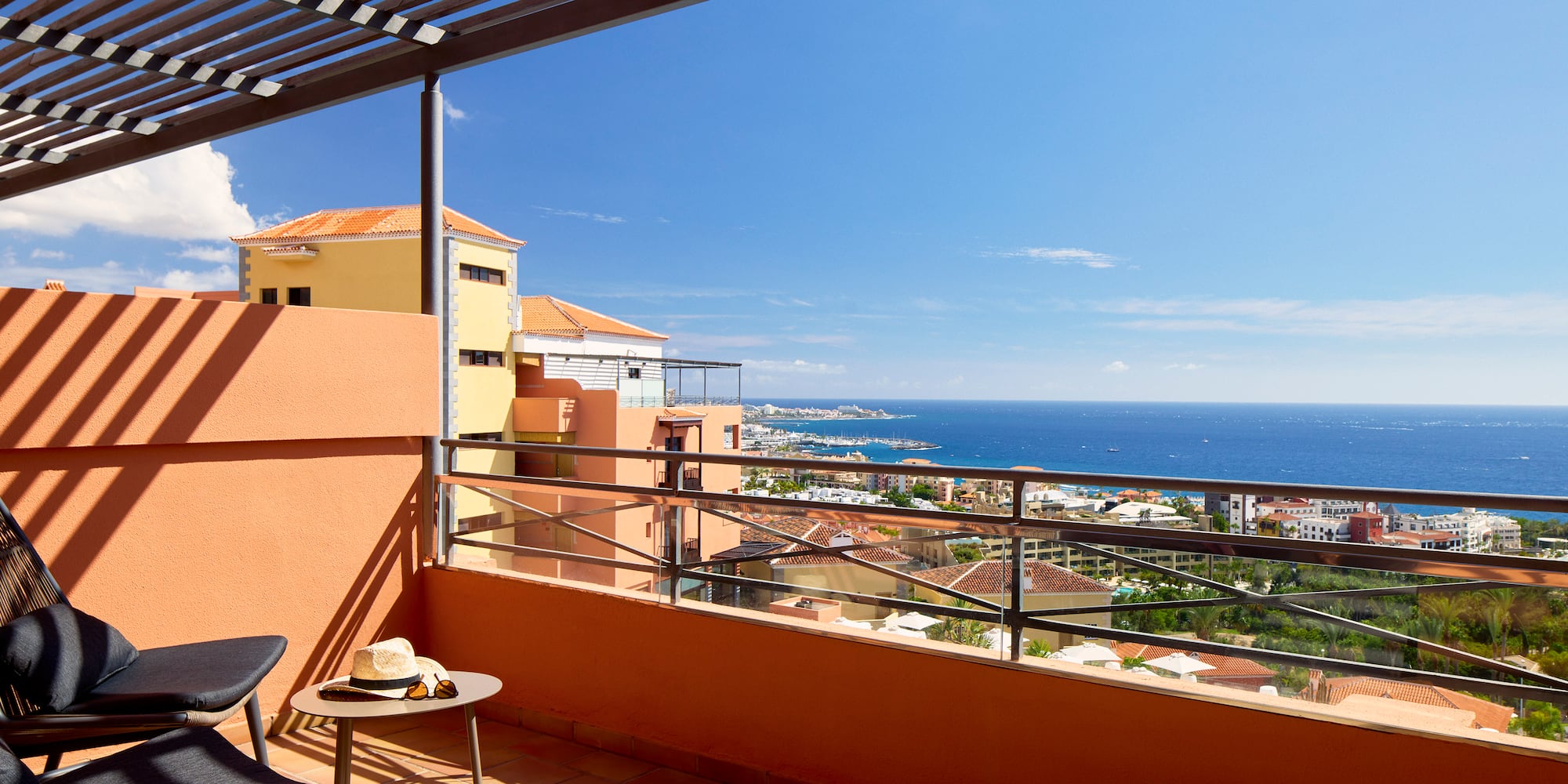 a balcony with a view of the ocean and a city