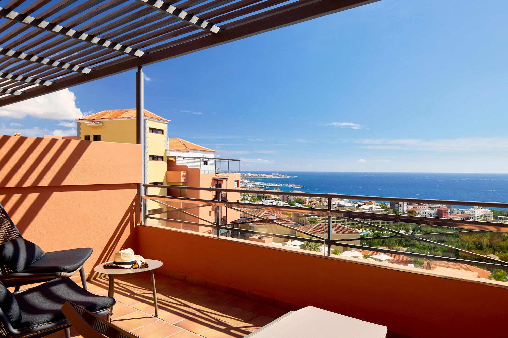 a balcony with a view of the ocean and a city