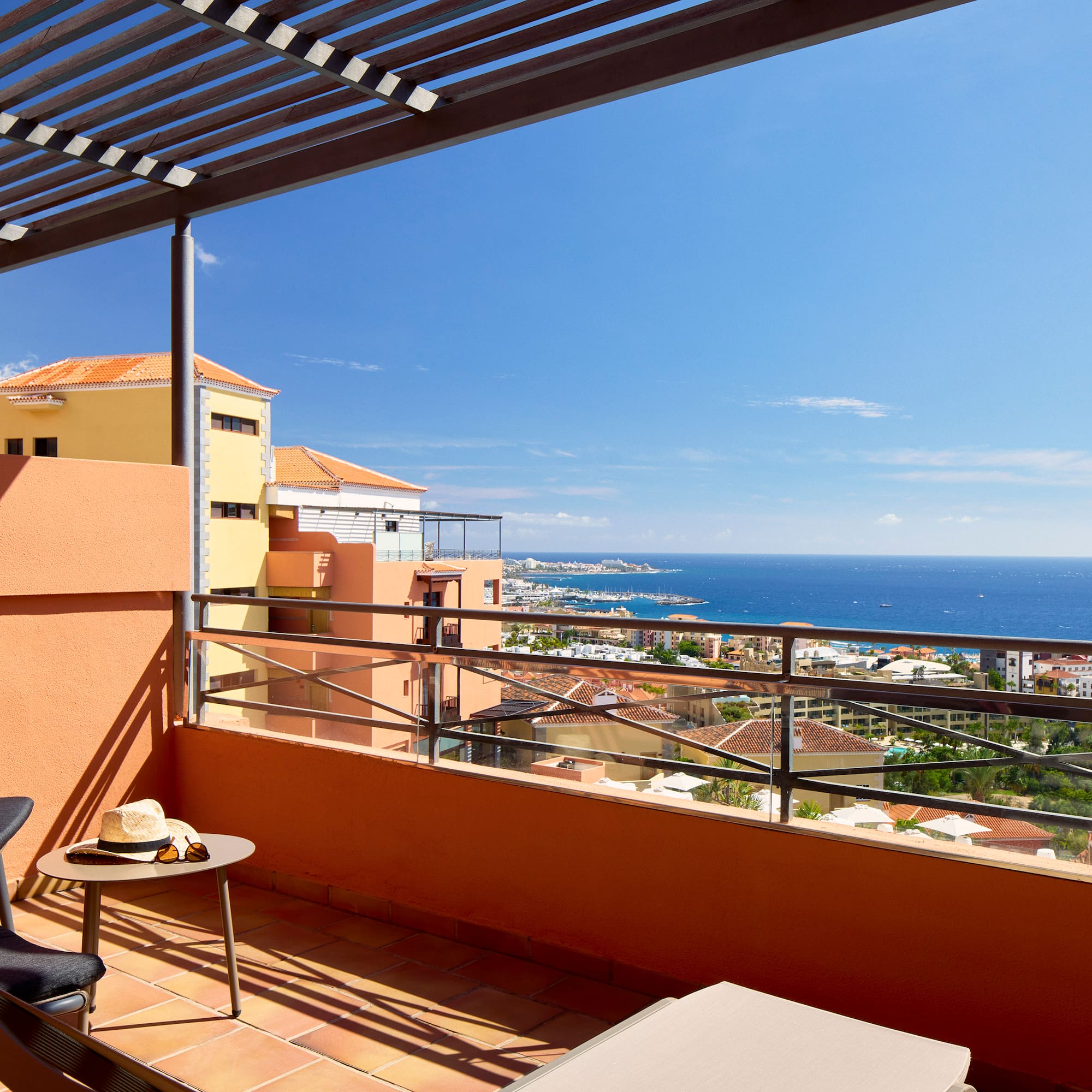 a balcony with a view of the ocean and a city