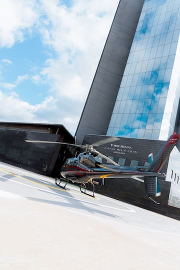 a helicopter parked in front of a building