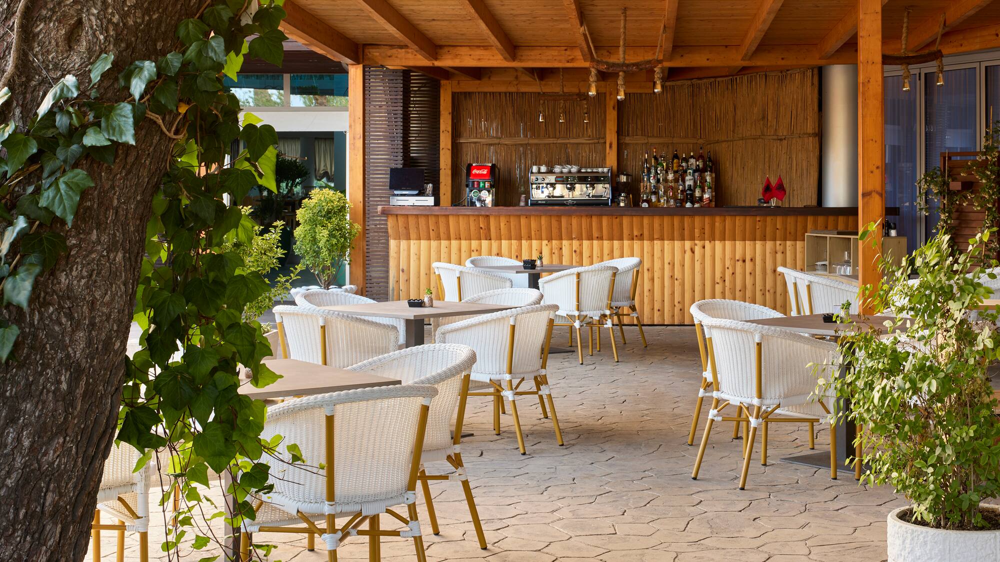a patio with tables and chairs