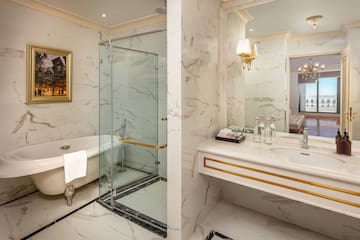 a bathroom with a glass shower and a bathtub