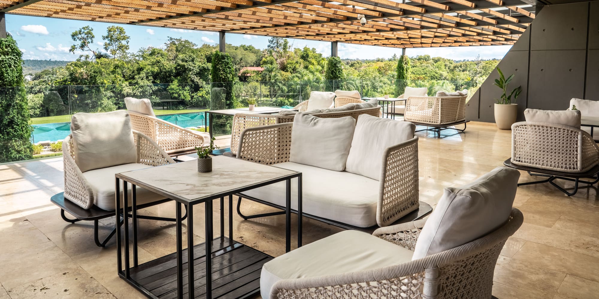 a patio with white furniture and a pool