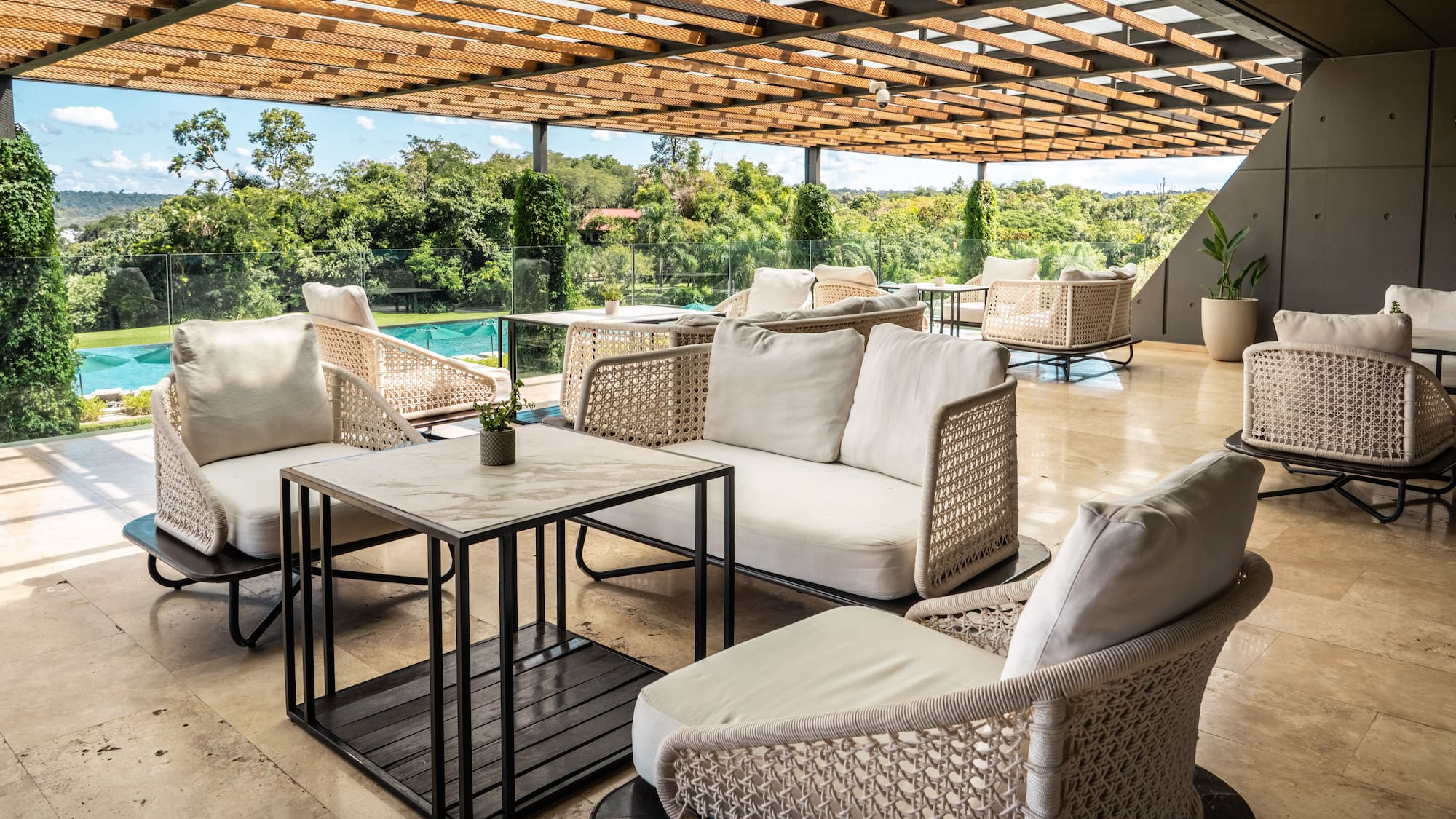 a patio with white furniture and a pool