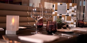 a table with wine glasses and plates