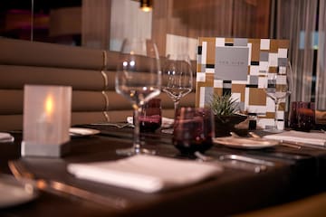 a table with wine glasses and plates