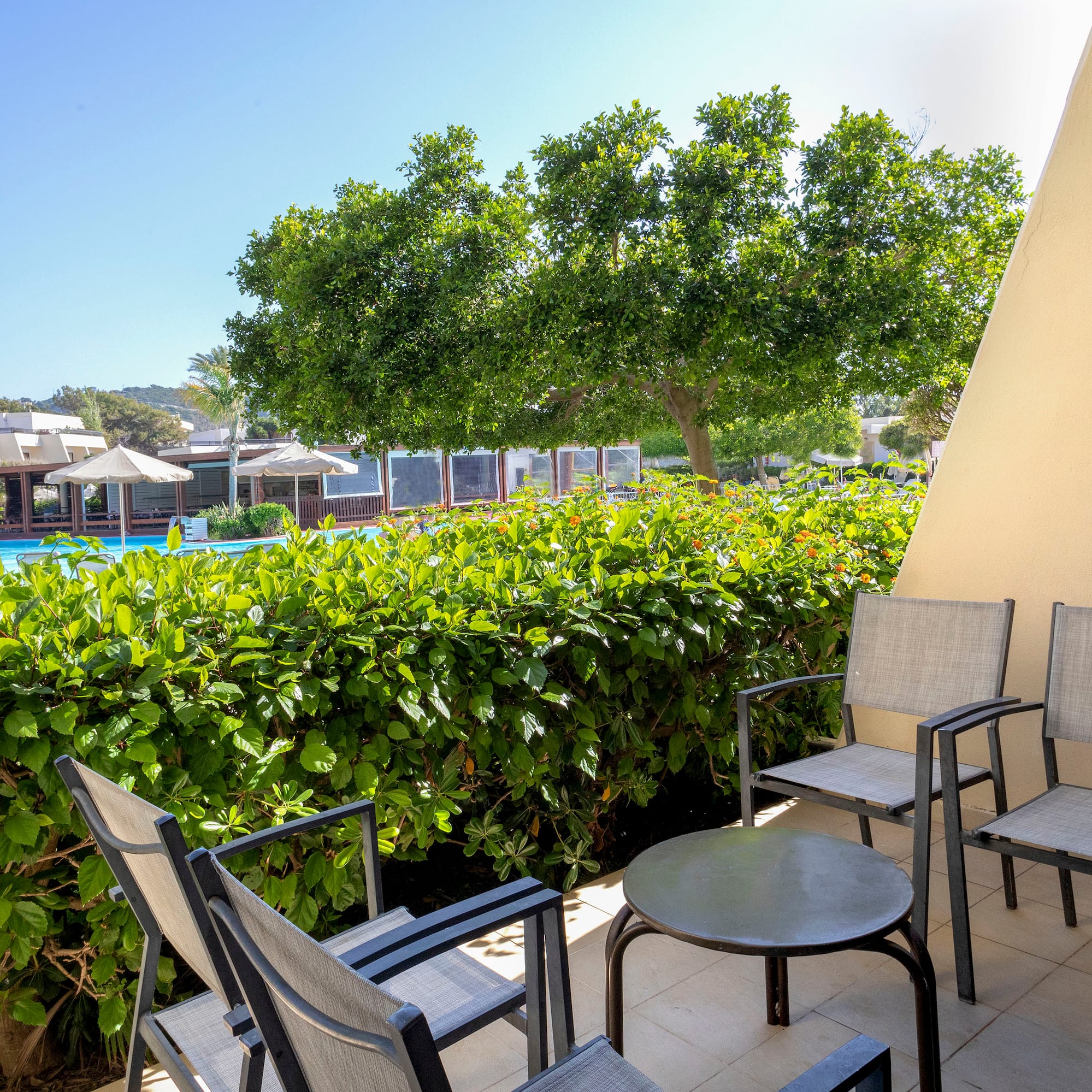 a patio with chairs and a table