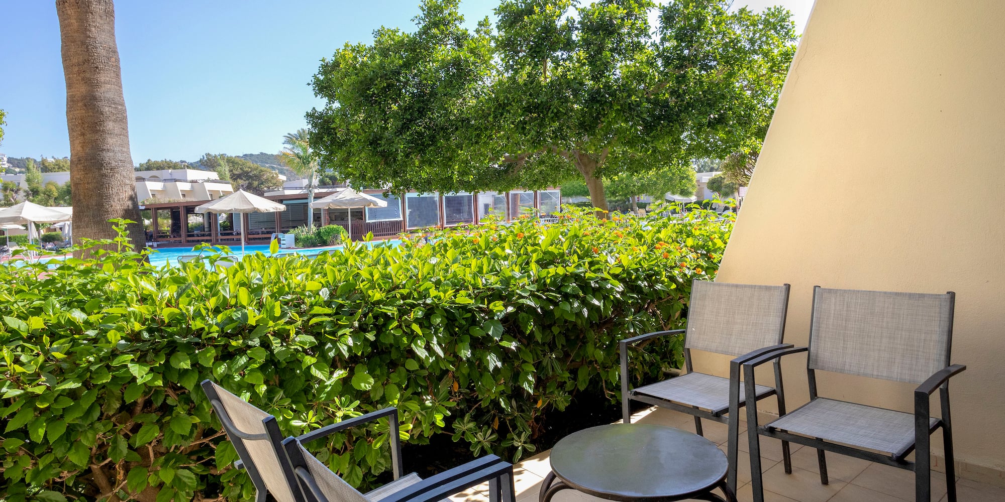 a patio with chairs and a table