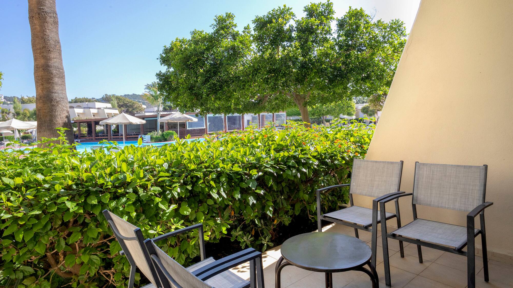 a patio with chairs and a table