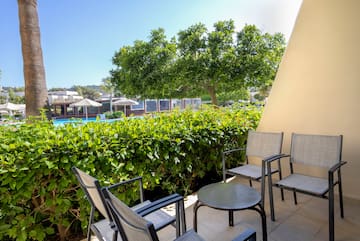 a patio with chairs and a table