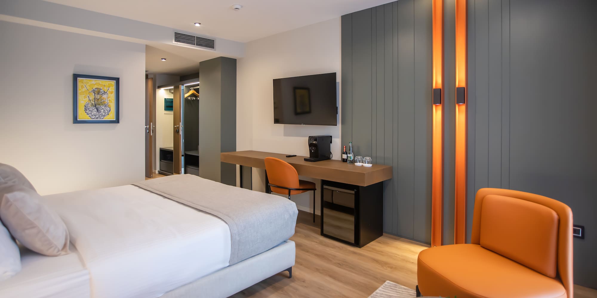 a room with a bed and a desk and chair