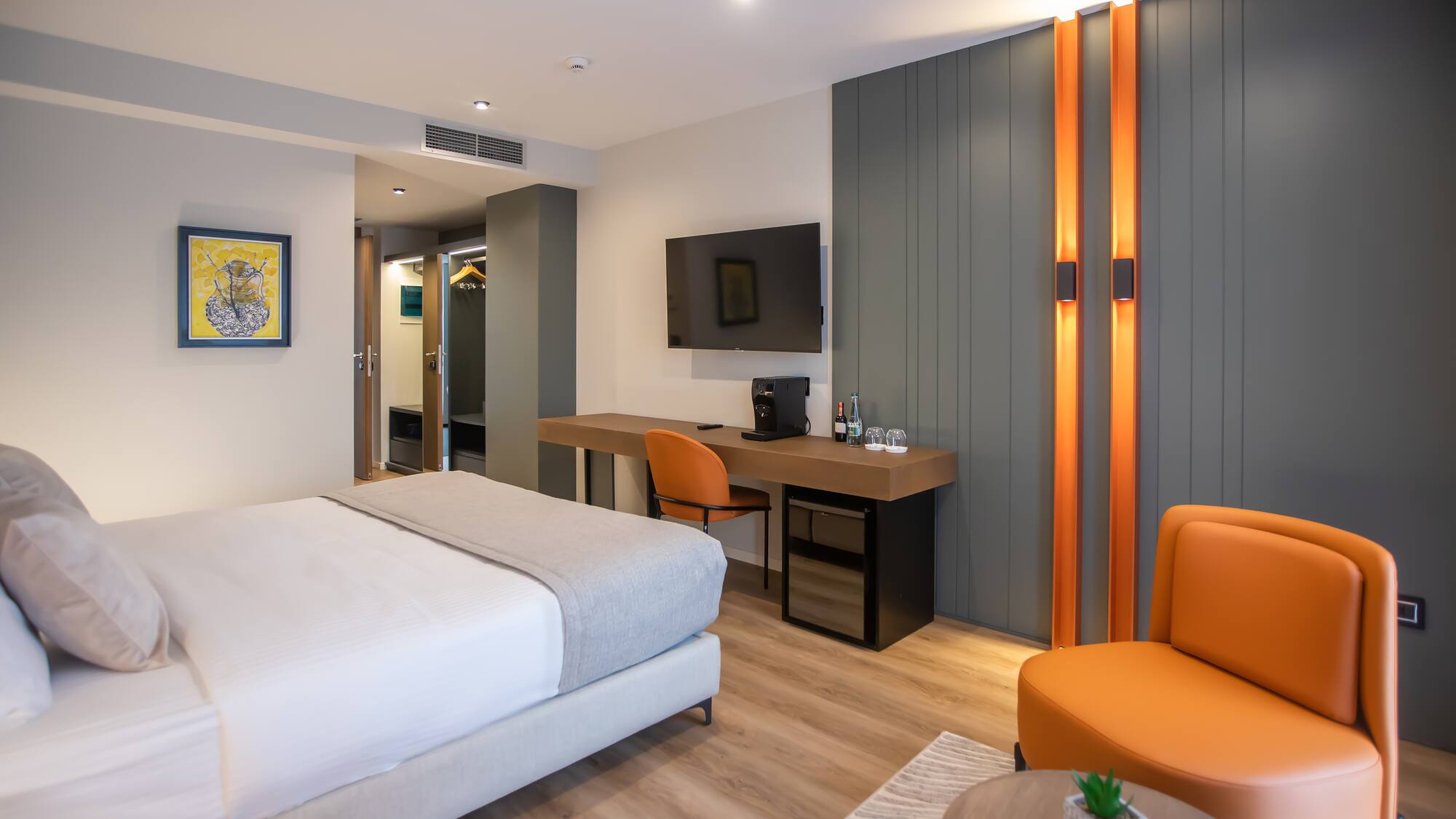 a room with a bed and a desk and chair