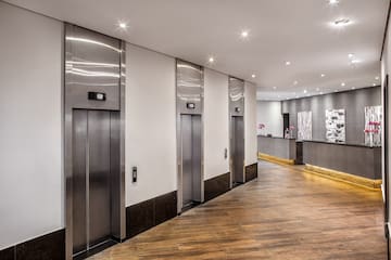 a hallway with elevators and a reception desk