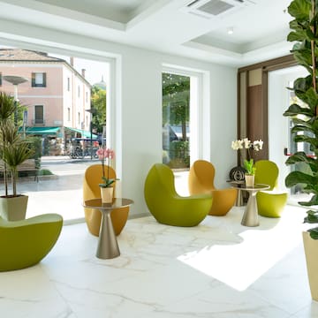 a room with chairs and tables and plants