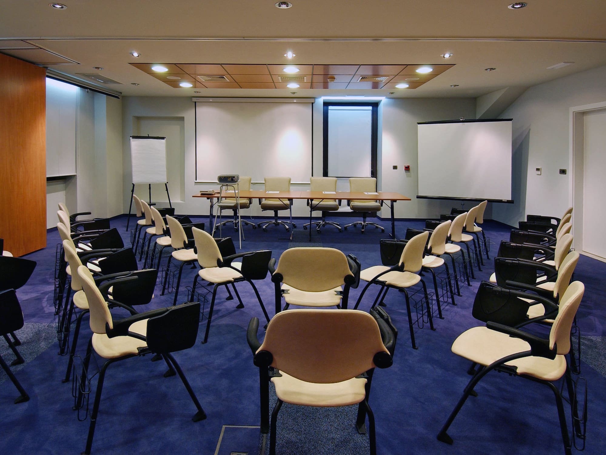 a room with chairs and a projector screen