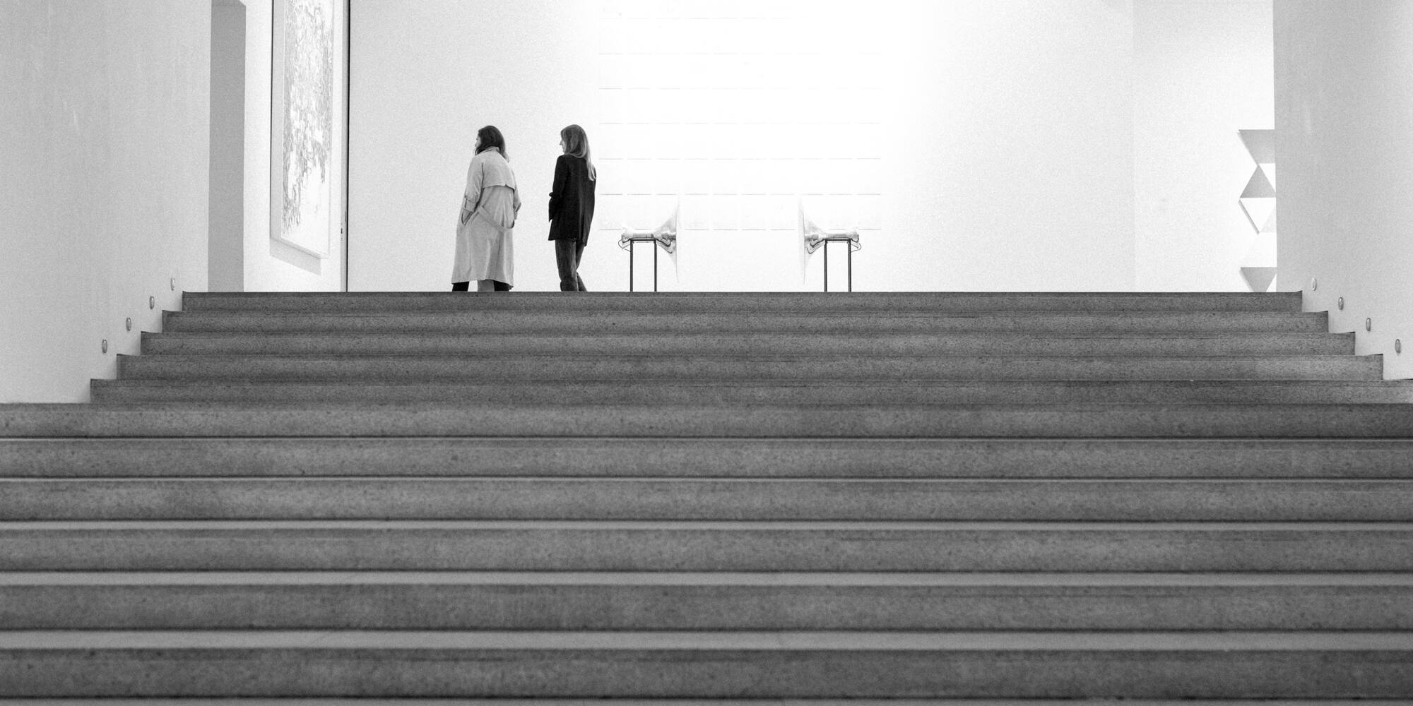two women walking up a staircase