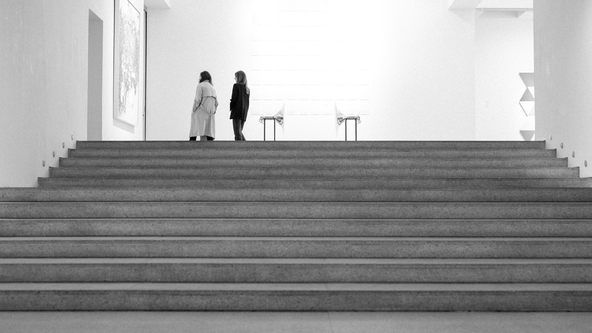 two women walking up a staircase