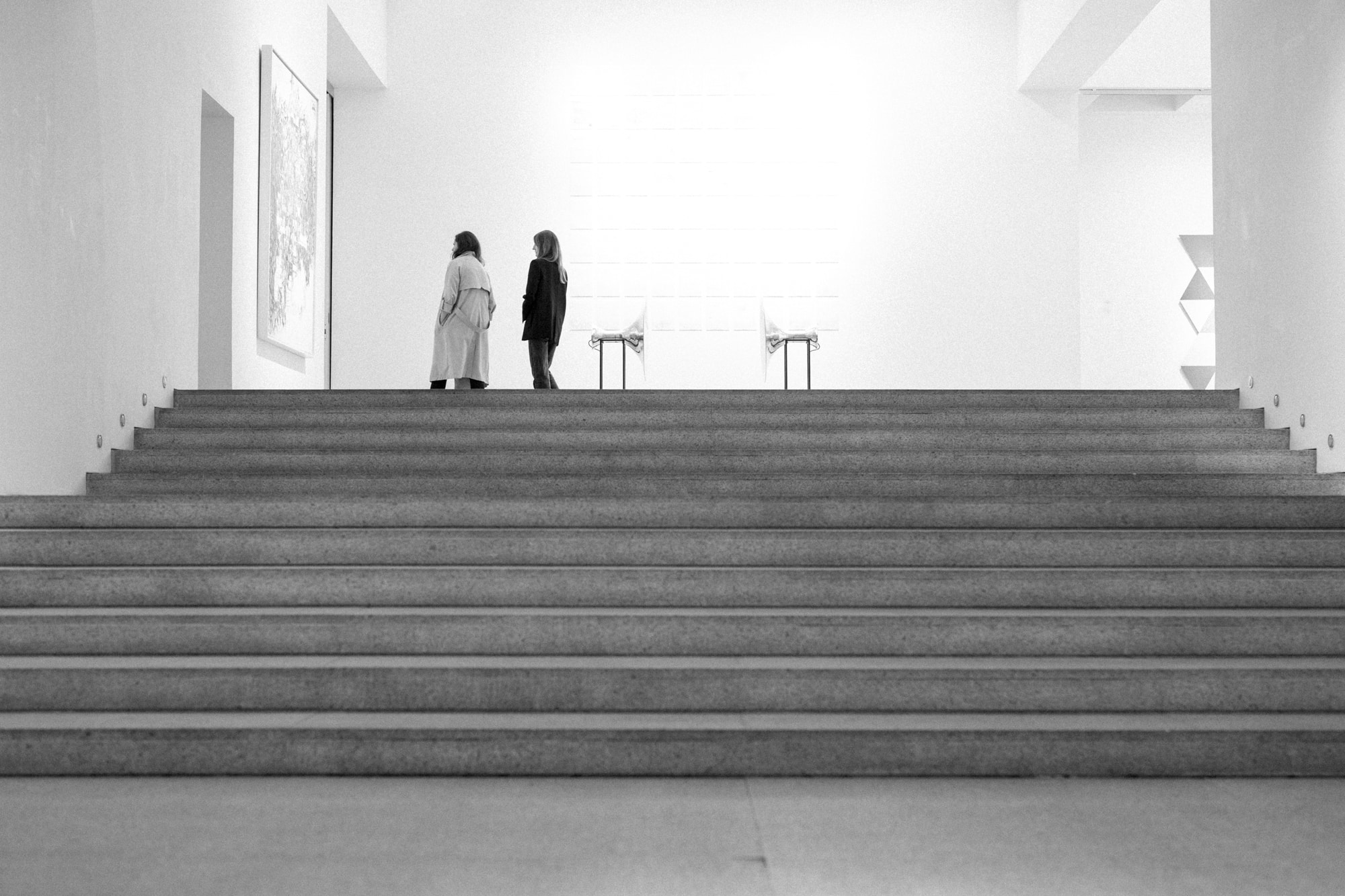 two women walking up a staircase