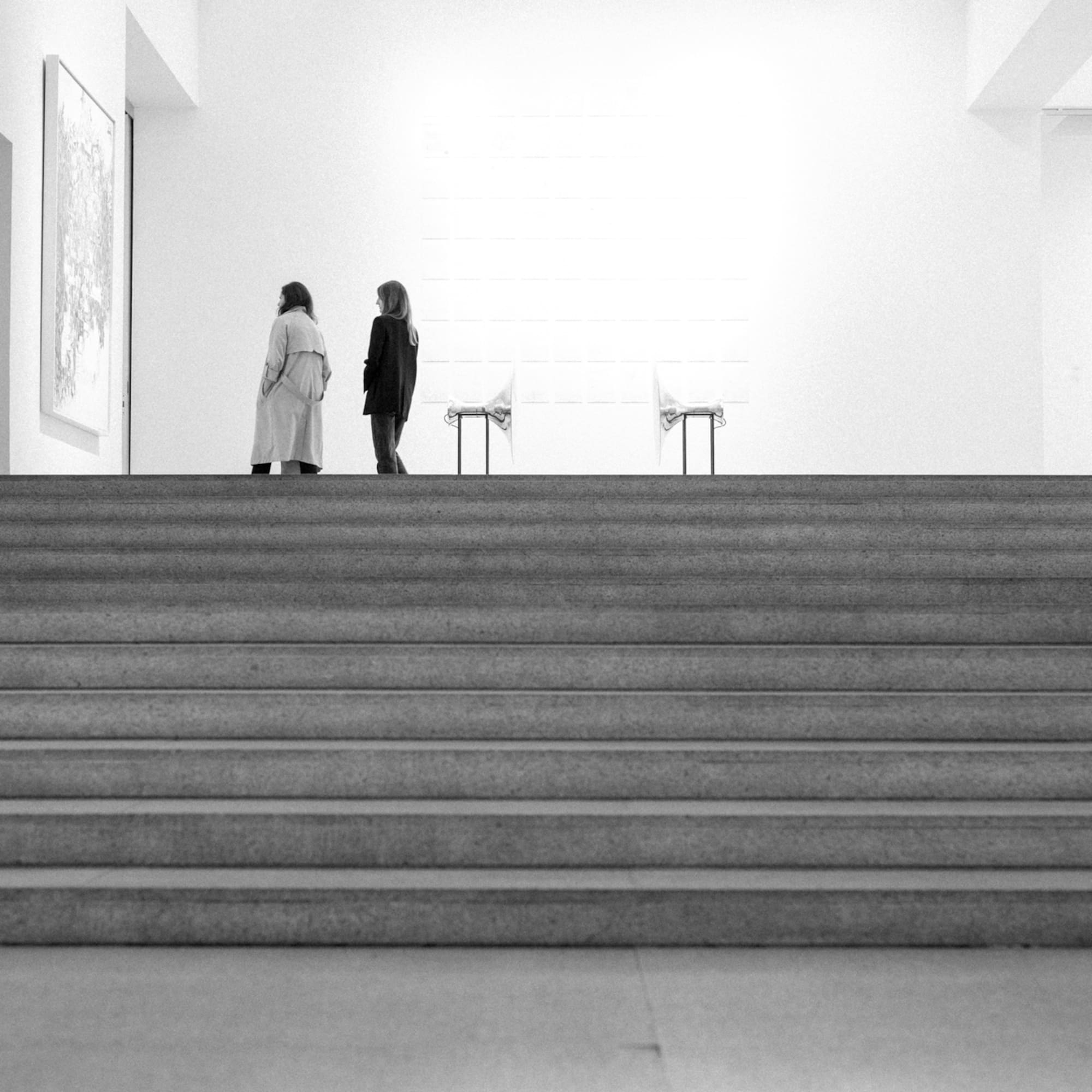 two women walking up a staircase