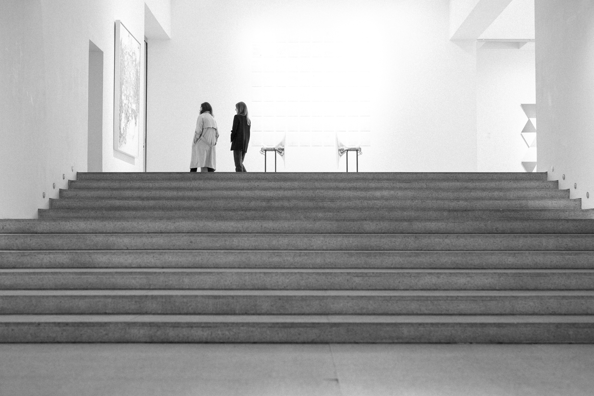 two women walking up a staircase