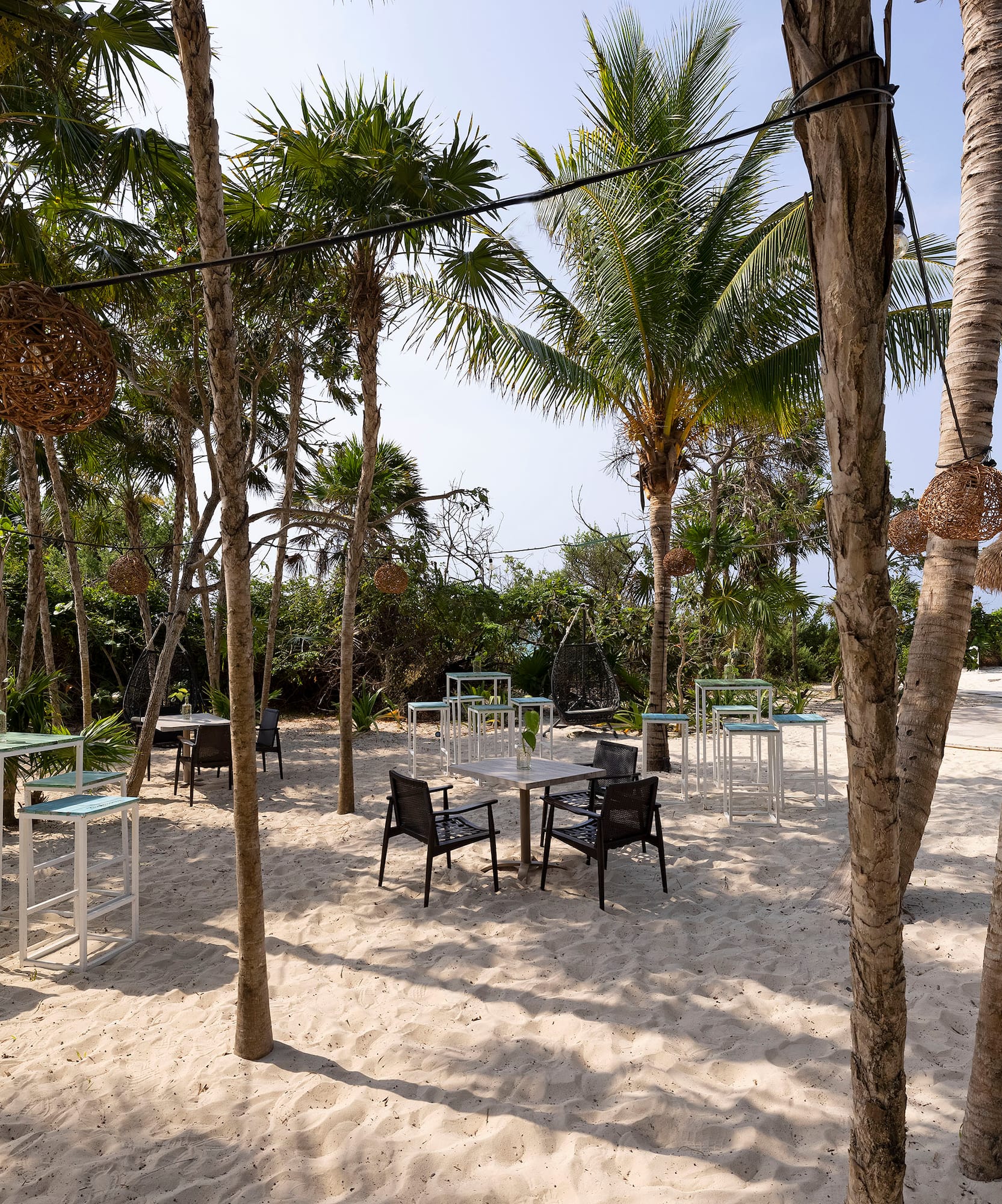 a group of tables and chairs on a beach